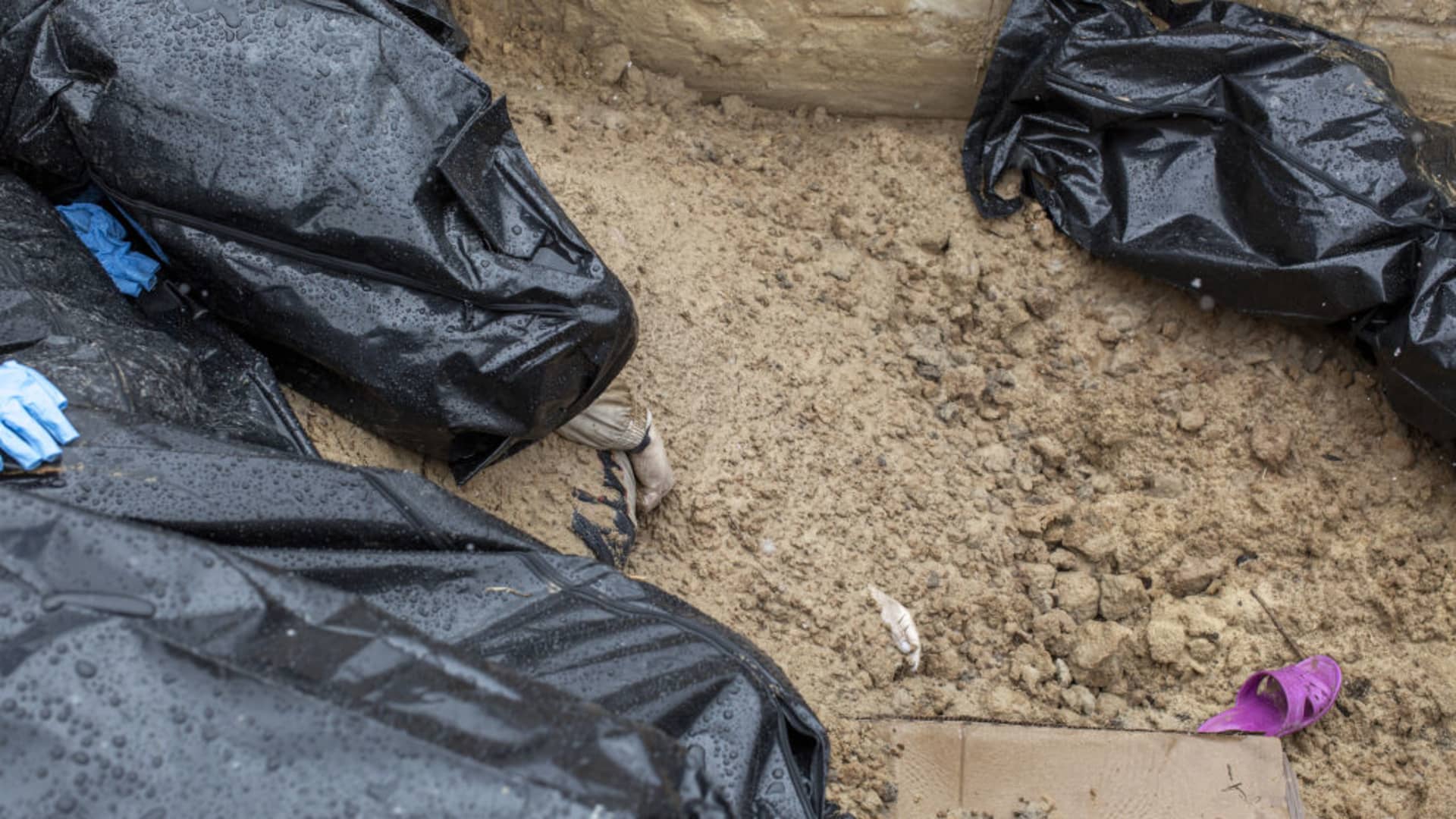 (EDITOR'S NOTE: Image depicts death) A partially buried body is seen in a mass grave in the town of Bucha, on the outskirts of Kyiv, after the Ukrainian army secured the area following the withdrawal of the Russian army from the Kyiv region on previous days, Bucha, Ukraine on April 03, 2022.