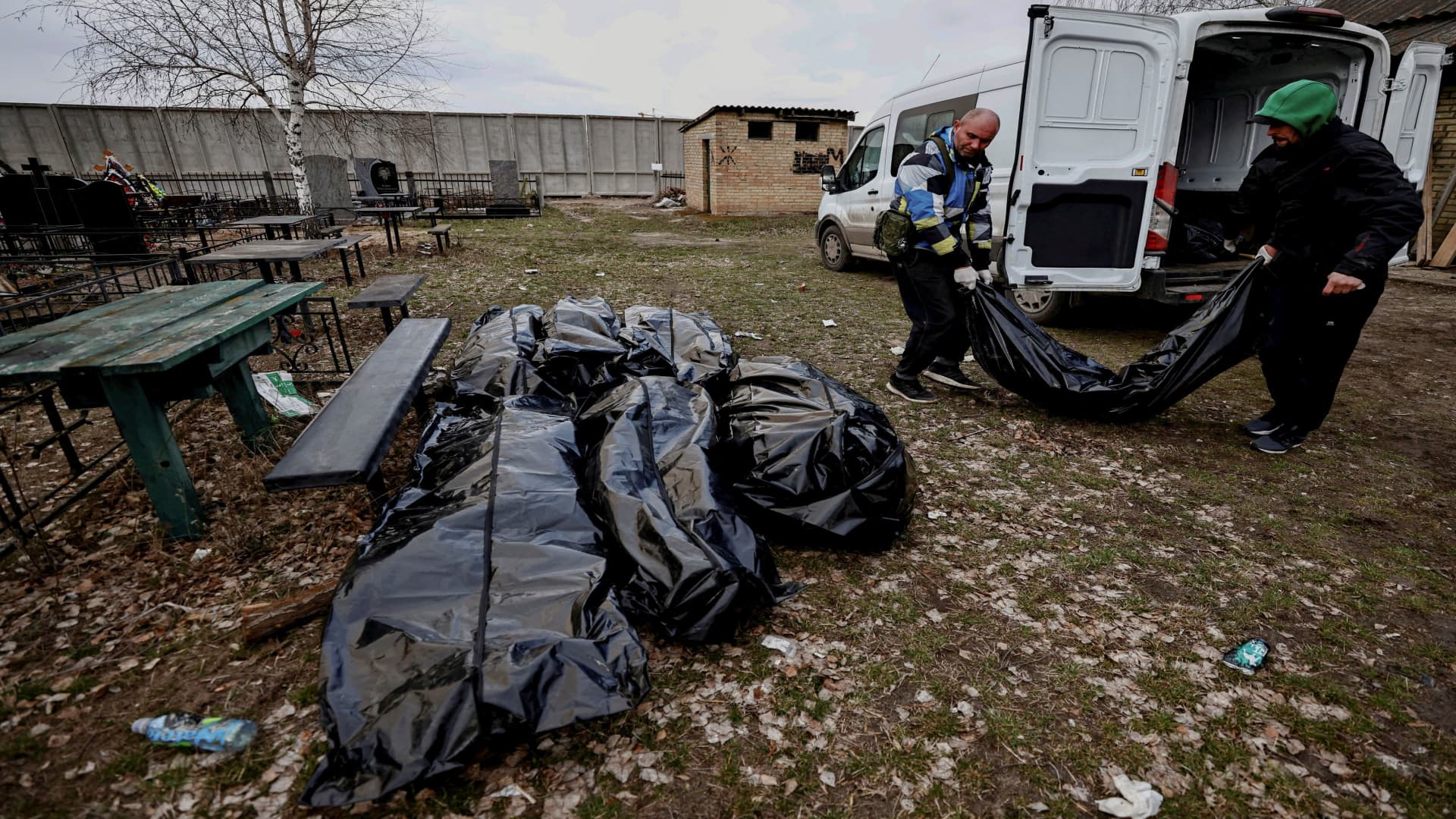 Volunteers unload from a van bags containing bodies of civilians, who according to residents were killed by Russian army soldiers, after they collected them from the streets to gather them at a cemetery before they take them to the morgue, amid Russia's invasion of Ukraine, in Bucha, in Kyiv region, Ukraine April 4, 2022. 