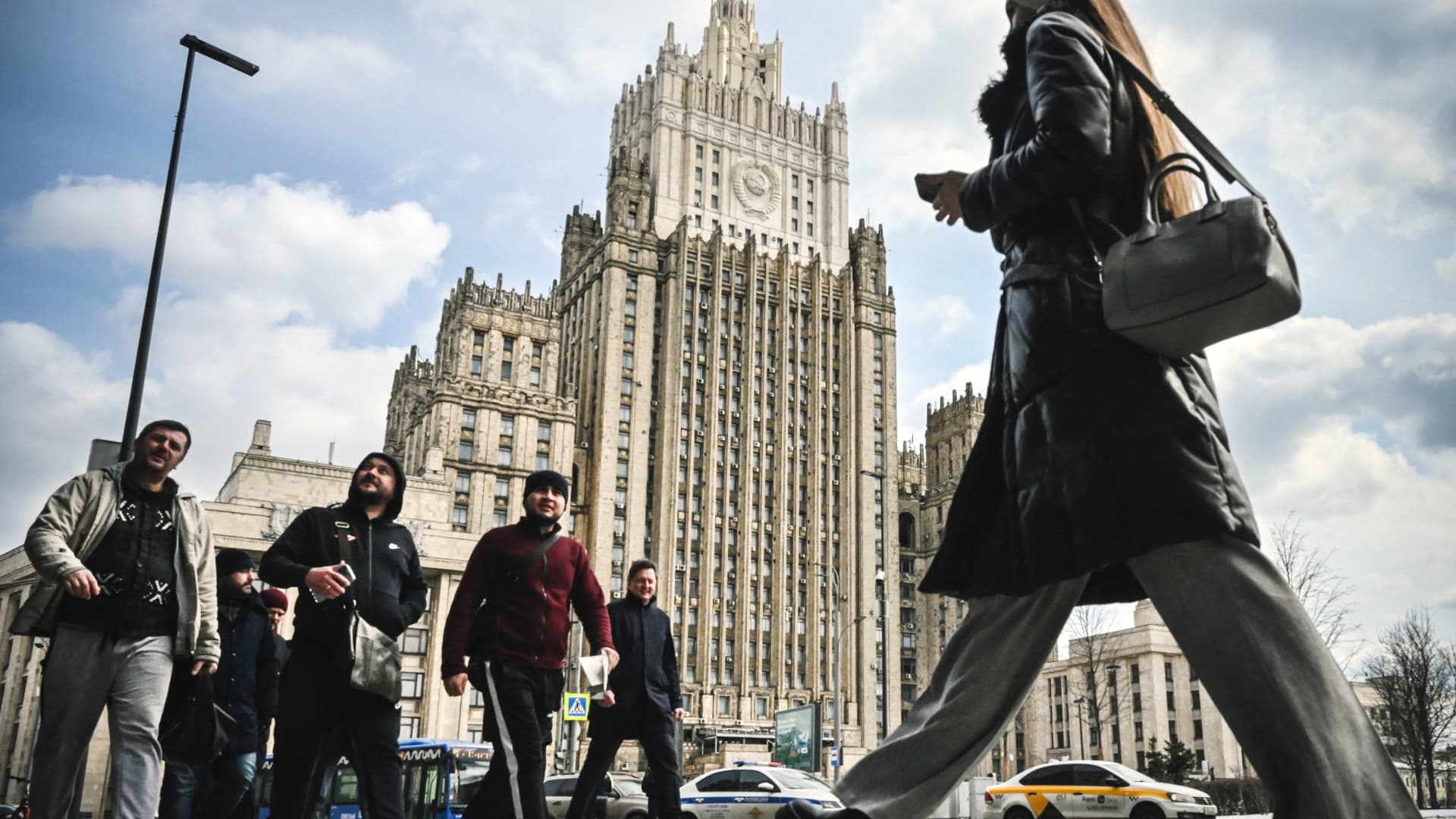 People walk past the Russian Foreign Ministry headquarters in Moscow on April 5, 2022. ties.