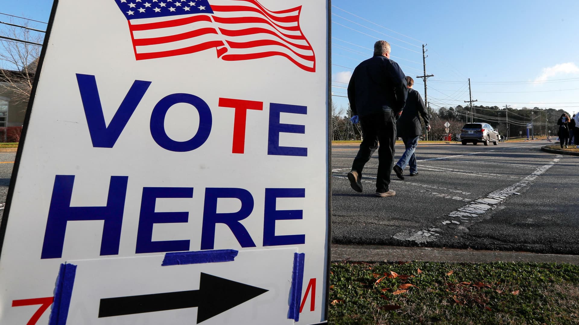 A sign is seen as voters line up for the U.S. Senate run-off election, at a polling location in Marietta, Georgia, January 5, 2021.