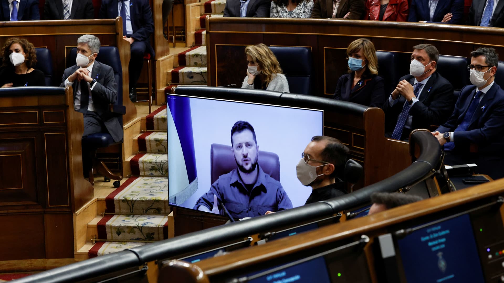 Ukrainian President Volodymyr Zelenskiy appears on a screen as he addresses members of Spanish parliament via video link, amid Russia's invasion of Ukraine, in Madrid, Spain, April 5, 2022.