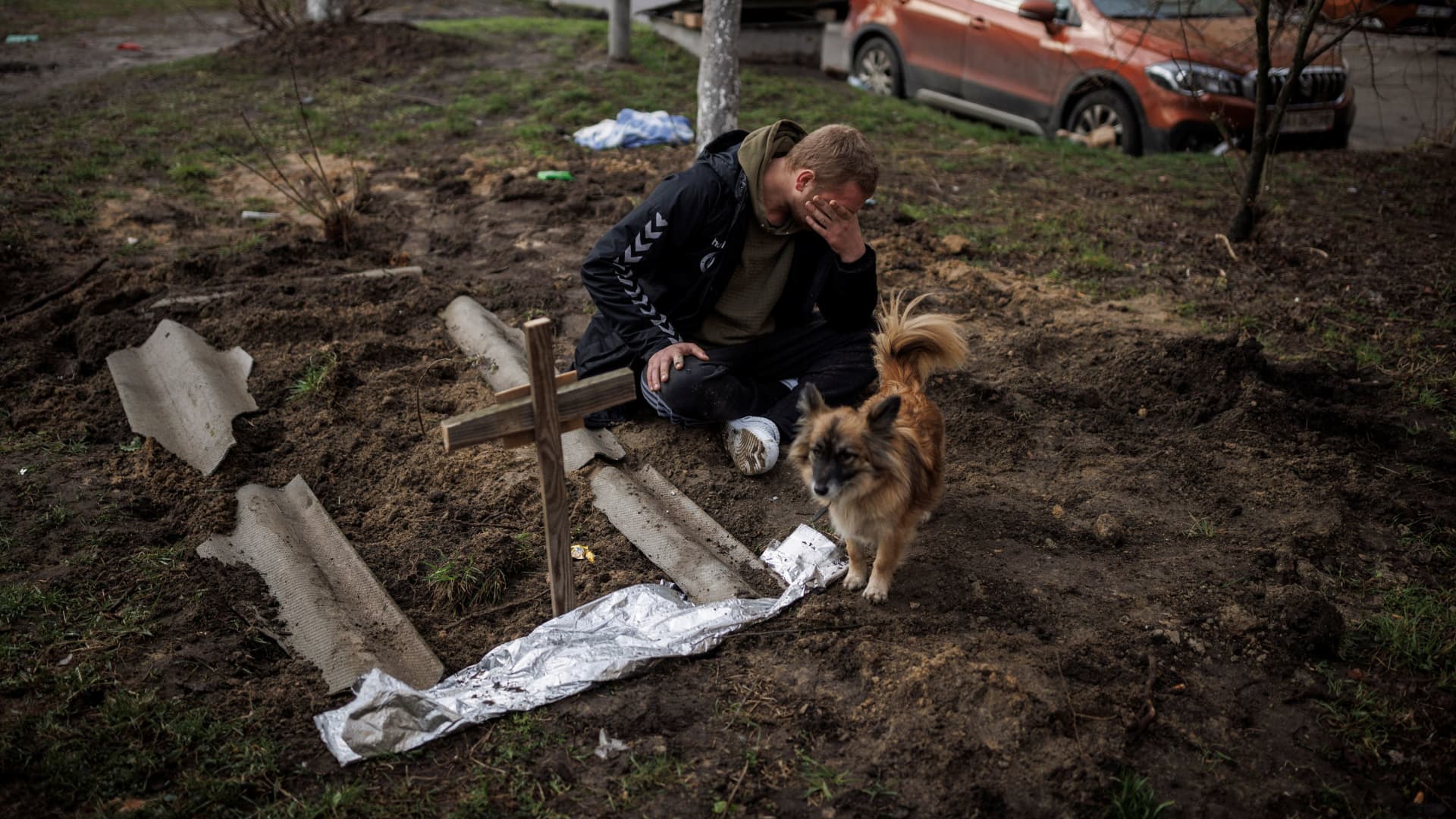 Serhii Lahovskyi, 26, mourns next to the grave of his friend Ihor Lytvynenko, who according to residents was killed by Russian soldiers, after they found him beside a building's basement, amid Russia's invasion of Ukraine, in Bucha, in Kyiv region, Ukraine, April 6, 2022. 