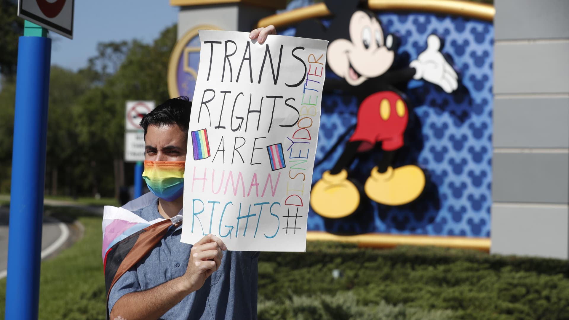 Disney employee Nicholas Maldonado holds a sign while protesting outside of Walt Disney World on March 22, 2022 in Orlando, Florida. Employees are staging a company-wide walkout today to protest Walt Disney Co.'s response to controversial legislation passed in Florida known as the “Don’t Say Gay” bill.