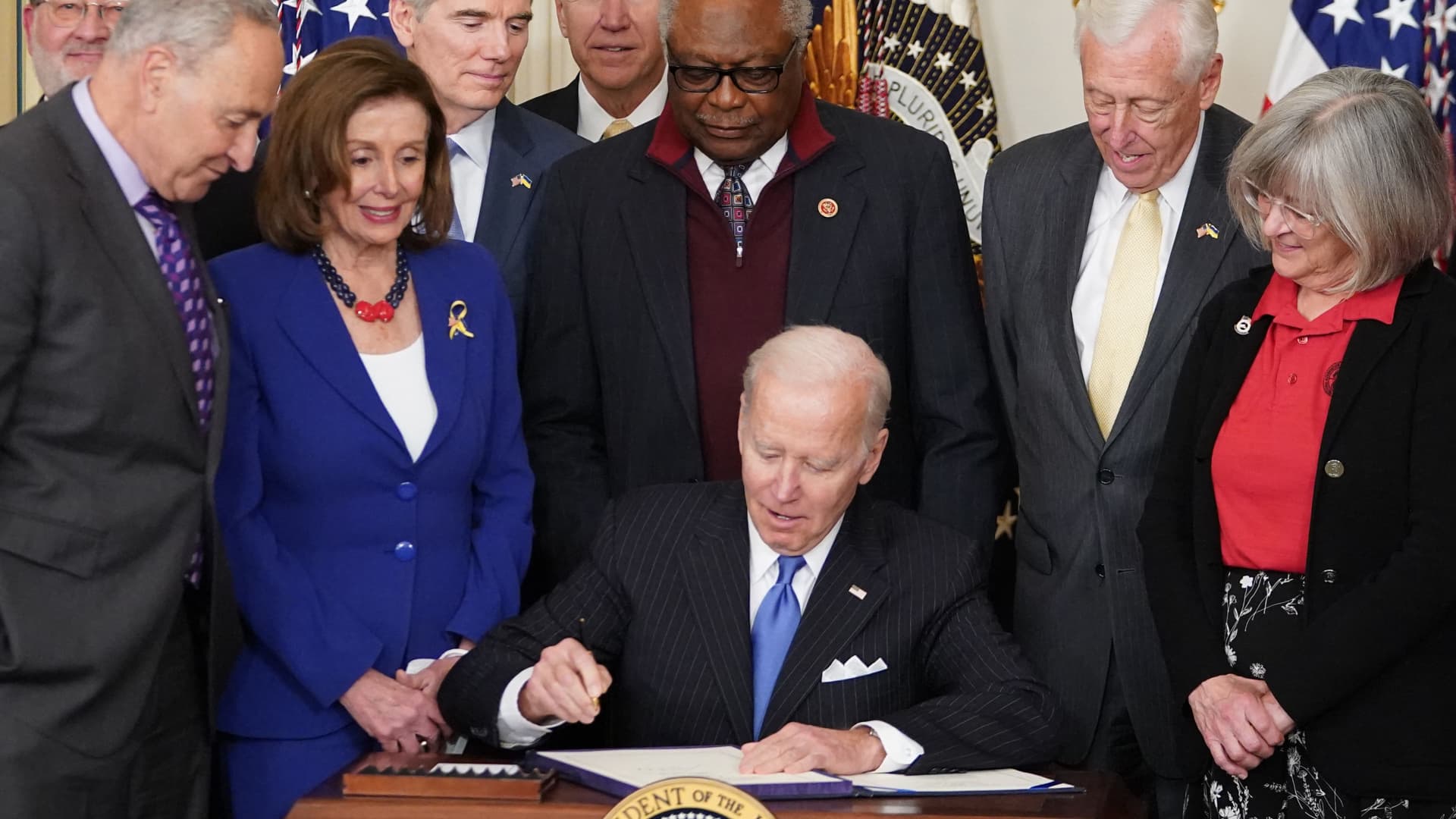 US President Joe Biden signs H.R. 3076, the Postal Service Reform Act of 2022, during a ceremony in the State Dining Room of the White House in Washington, DC, on April 6, 2022.