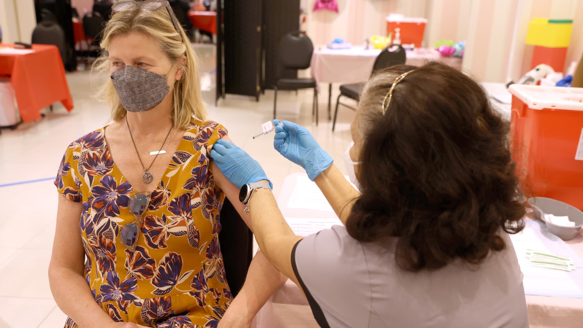 A nurse administers a booster shot at a Covid-19 vaccination clinic on April 0=6, 2022 in San Rafael, California.