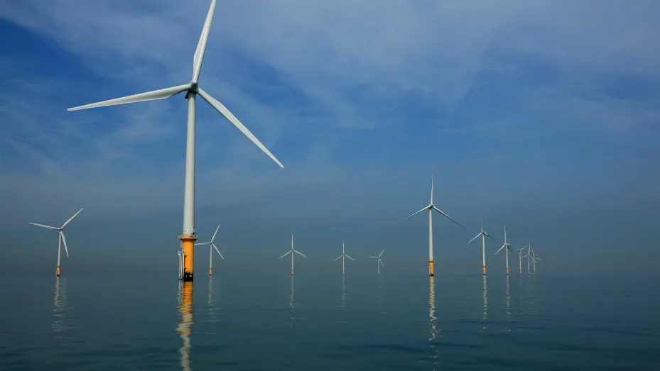 LIVERPOOL, UNITED KINGDOM - MAY 12: Turbines of the new Burbo Bank off shore wind farm stand in a calm sea in the mouth of the River Mersey on May 12, 2008 in Liverpool, England. The Burbo Bank Offshore Wind Farm comprises 25 wind turbines and is situated on the Burbo Flats in Liverpool Bay at the entrance to the River Mersey, approximately 6.4km (4.0 miles) from the Sefton coastline and 7.2km (4.5 miles) from North Wirral. The wind farm is capable of generating up to 90MW (megawatts) of clean, environment