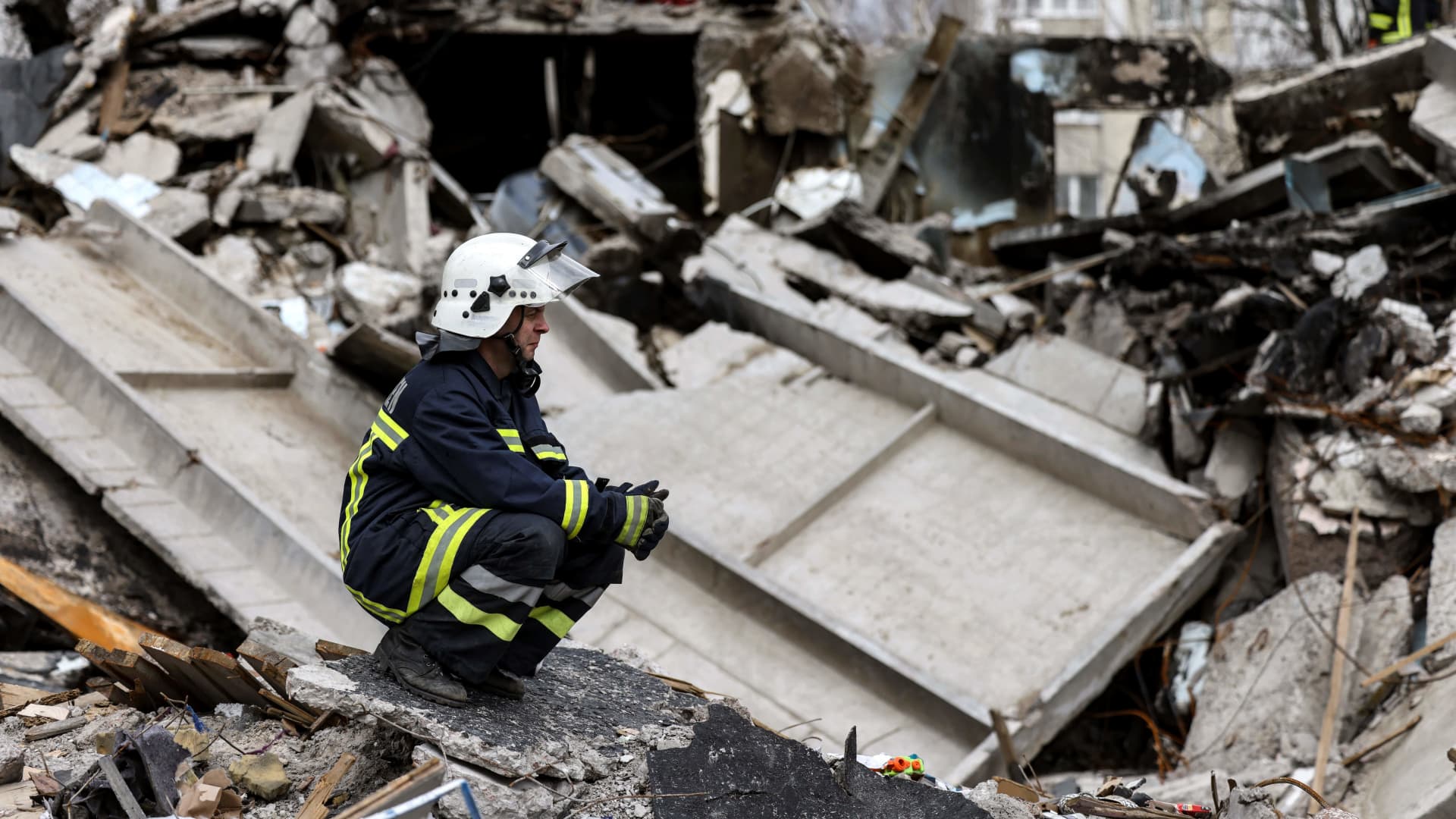 Ukrainian firefighters search for bodies in the rubble of destroyed buildings in the town of Borodianka, northwest of Kyiv, on April 8, 2022.
