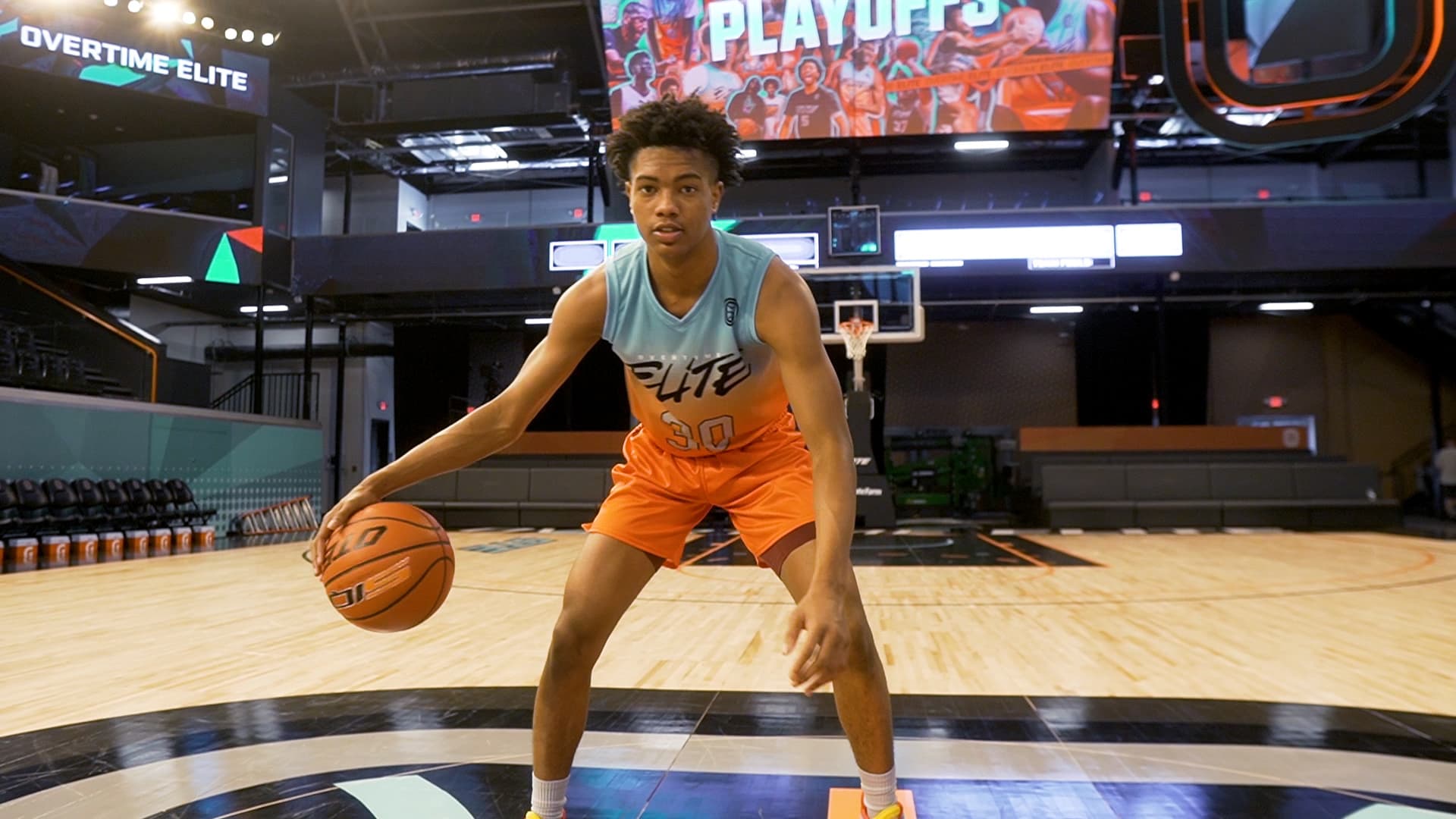Bryson Warren, a 17-year-old professional high school athlete, dribbles a basketball in the Overtime Elite arena in Atlanta.