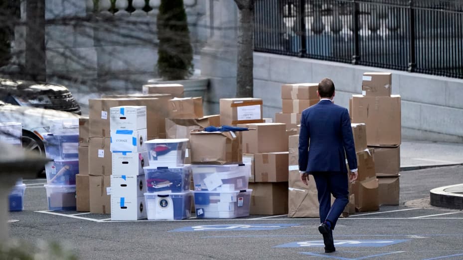 A man walks past boxes that were moved out of the Eisenhower Executive Office building, just outside the West Wing, inside the White House complex, Thursday, Jan. 14, 2021, in Washington.