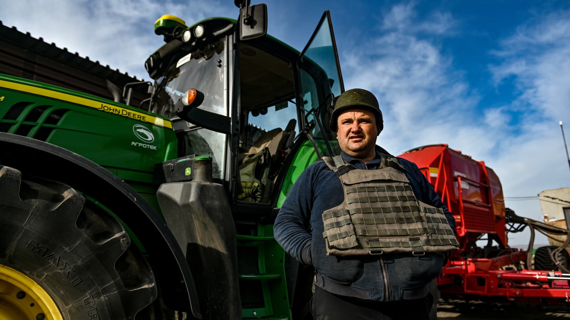 A farmer wears a bulletproof vest during crop sowing which takes place about 18 miles from the front line in the Zaporizhzhia Region, southeastern Ukraine.