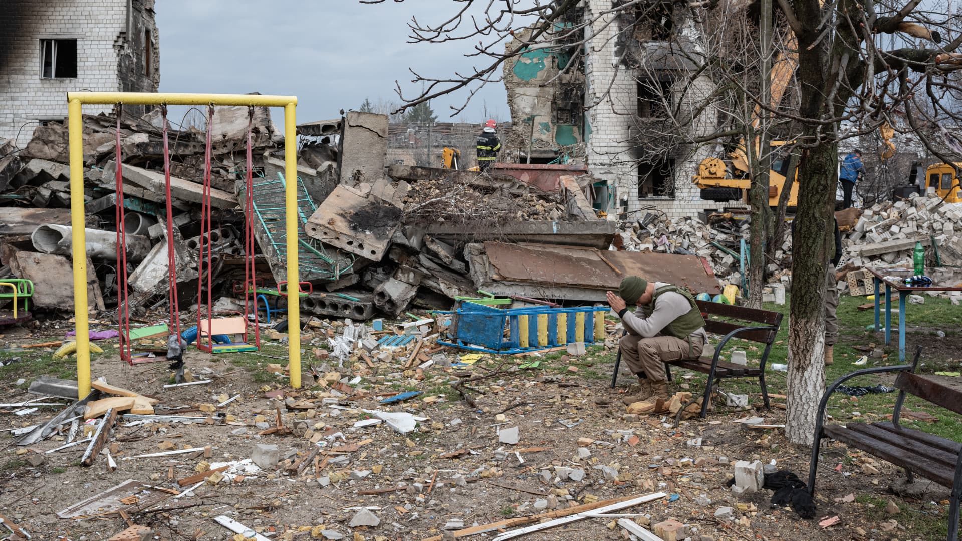 Leo, 22, a volunteer from the US, prays by the destroyed apartment building on April 9, 2022 in Borodianka, Ukraine. The Russian retreat from towns near Kyiv has revealed scores of civilian deaths and the full extent of devastation from Russia's attempt to seize the Ukrainian capital.