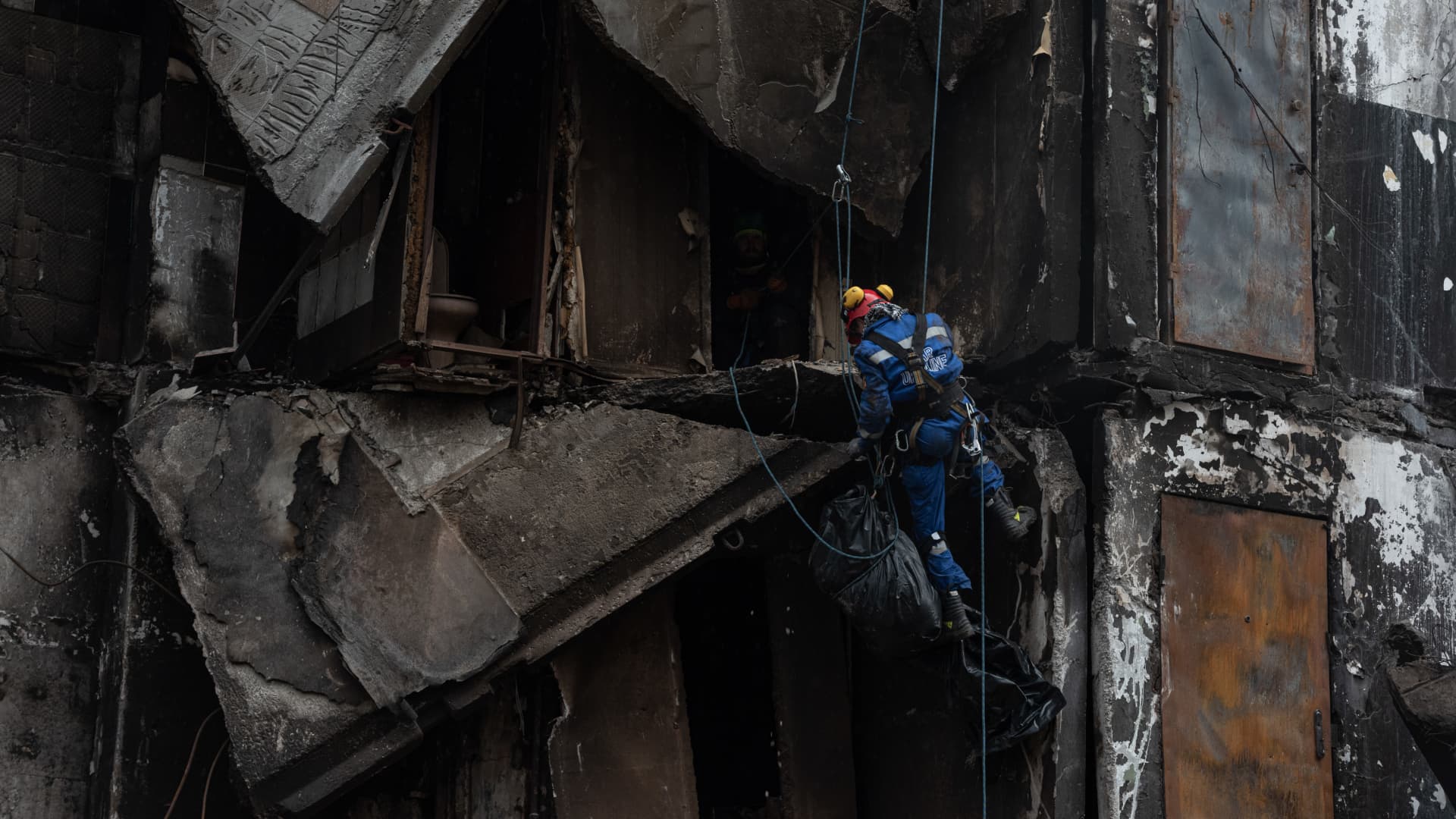 Rescue workers remove a body from the rubble of a destroyed apartment building, on April 9, 2022 in Borodianka, Ukraine. 