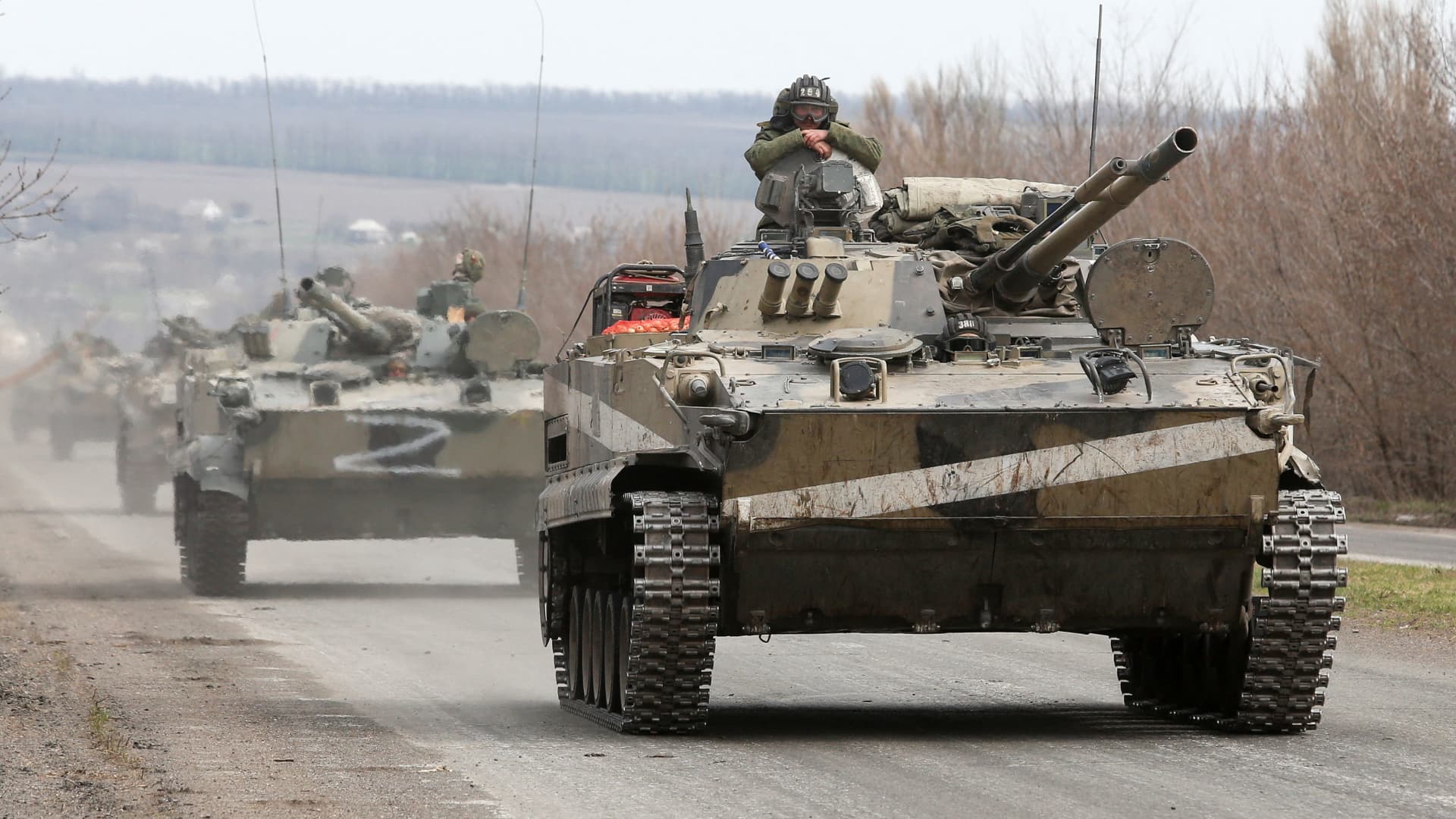 Service members of pro-Russian troops drive armoured vehicles during Ukraine-Russia conflict on a road outside the southern port city of Mariupol, Ukraine April 10, 2022.