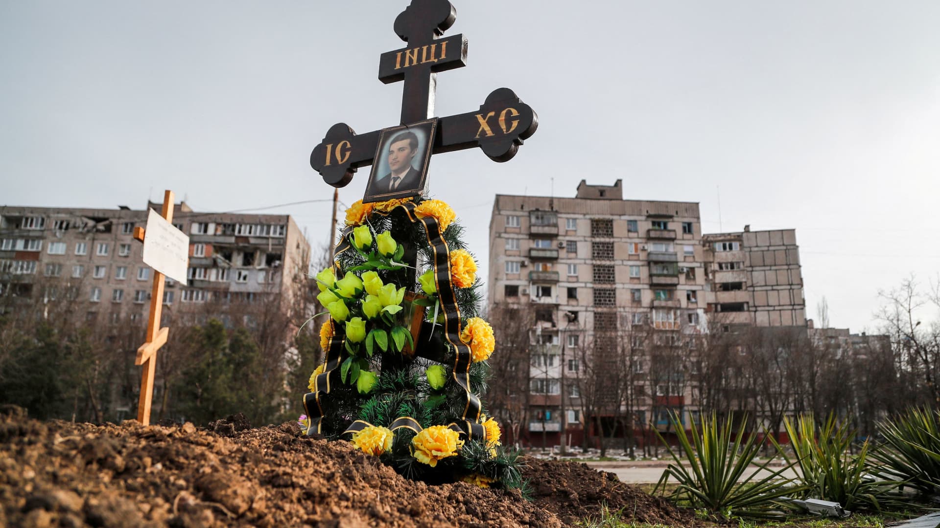 Graves of civilians killed during Ukraine-Russia conflict are seen next to apartment buildings in the southern port city of Mariupol, Ukraine April 10, 2022. 