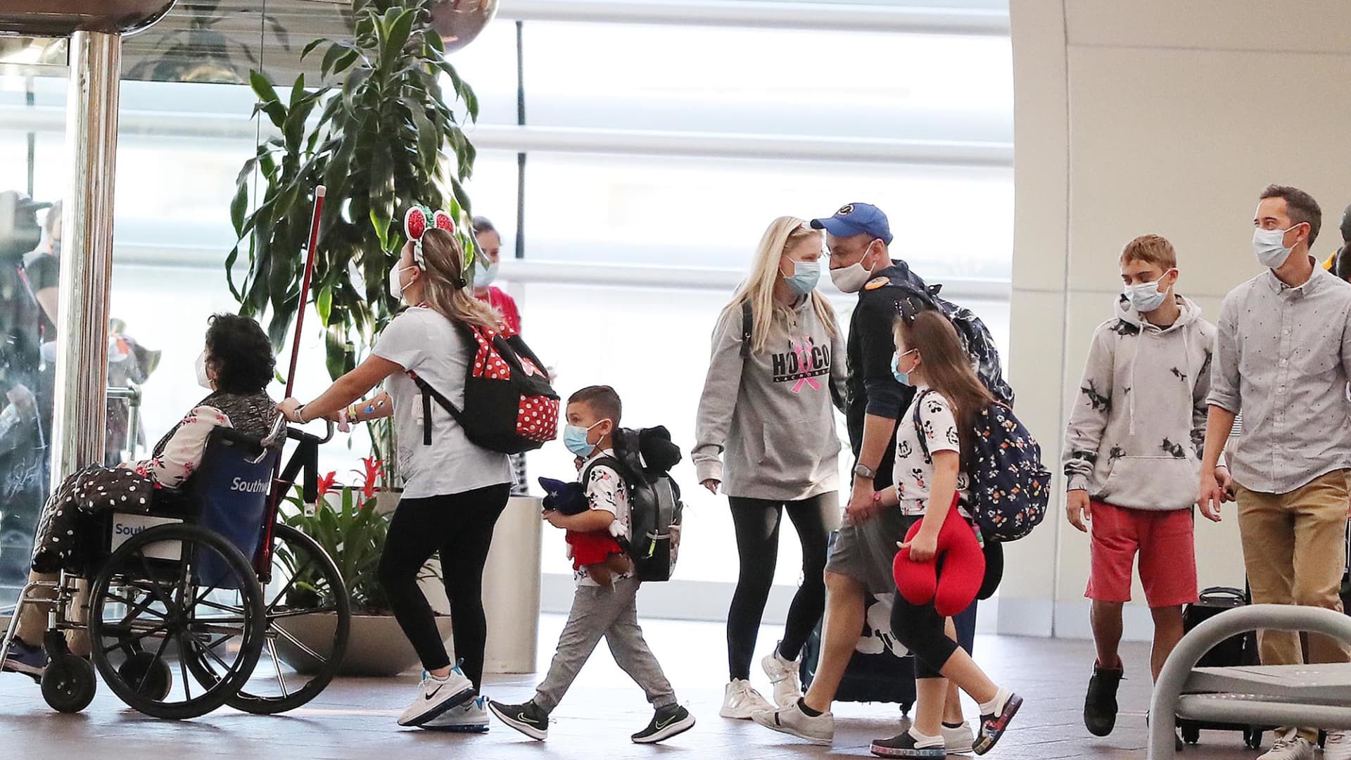 Travelers walk through Terminal A at Orlando International Airport on Christmas Day, Saturday, December 25, 2021.