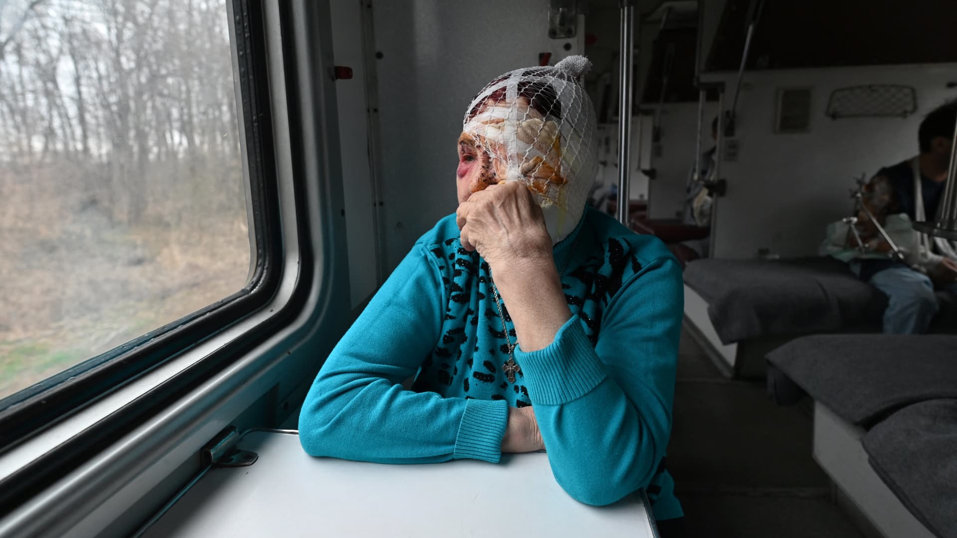 Praskovya, 77, watches out of a window of a medical evacuation train on its way to the western Ukrainian city of Lviv on April 10, 2022.