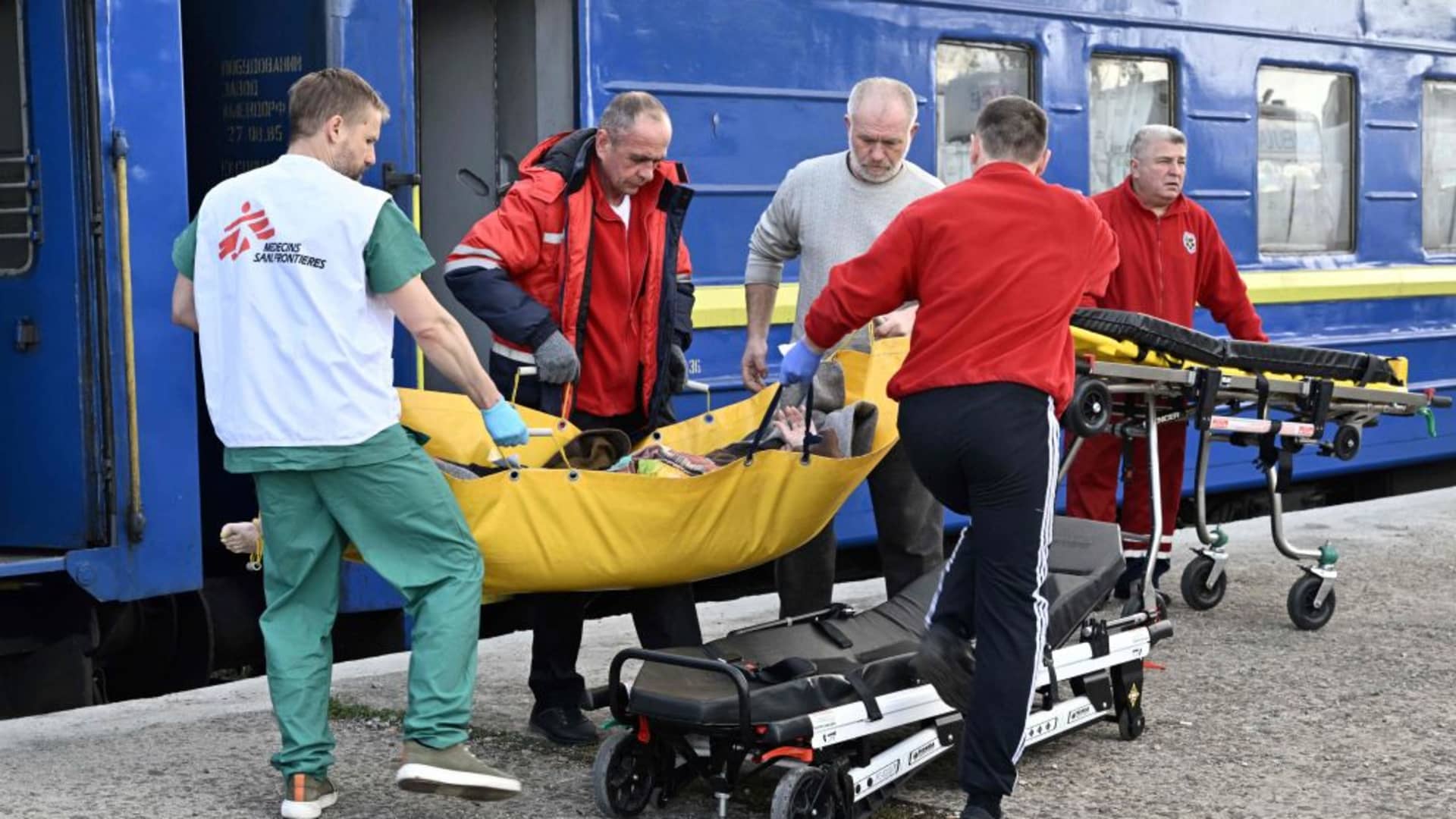Ambulance workers and MSF medics transfer a patient to an ambulance in the western Ukrainian city of Lviv on April 10, 2022