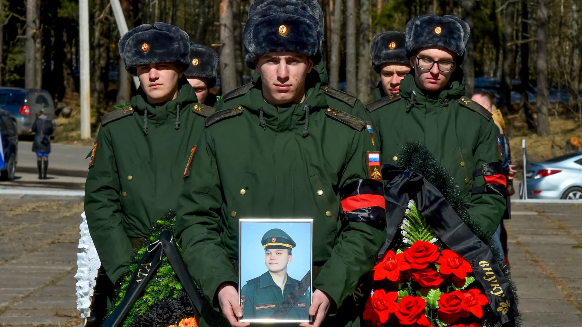 Russian soldiers carry wreathes and a picture of 20-year-old Russian serviceman Nikita Avrov, during his funeral in Luga, some 150kms south of Saint Petersburg on April 11, 2022, after his death on March 27, during the ongoing Russian invasion of Ukraine.