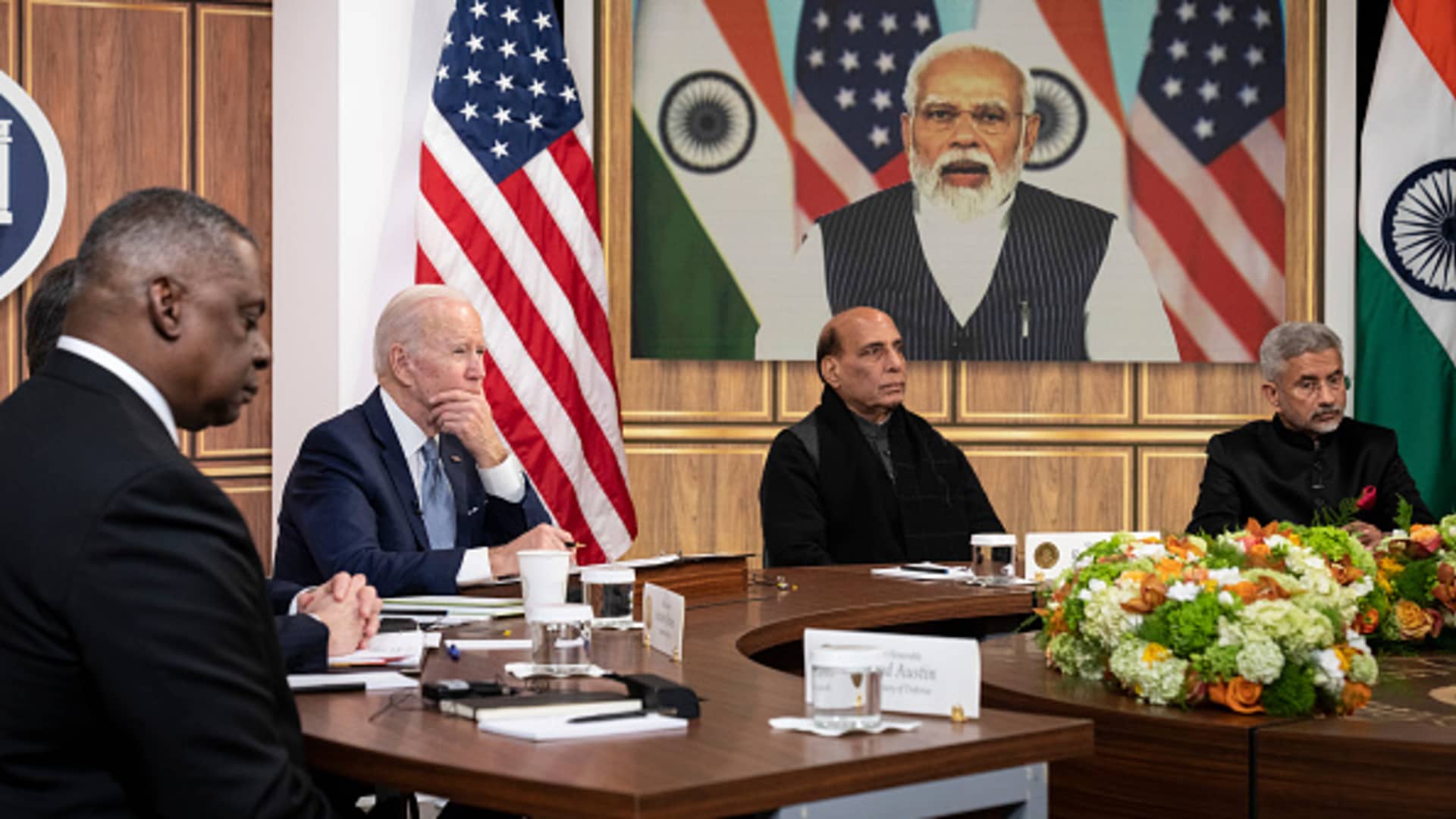 (L-R) U.S. Defense Secretary Lloyd Austin, U.S. President Joe Biden, Indian Minister of Defense Rajnath Singh, and Indian Foreign Minister Subrahmanyam Jaishankar listen as Prime Minister of India Narendra Modi (on screen) speaks during a virtual meeting in the South Court Auditorium of the White House complex April 11, 2022 in Washington, DC. India has maintained a neutral stance so far in Russias invasion of Ukraine.
