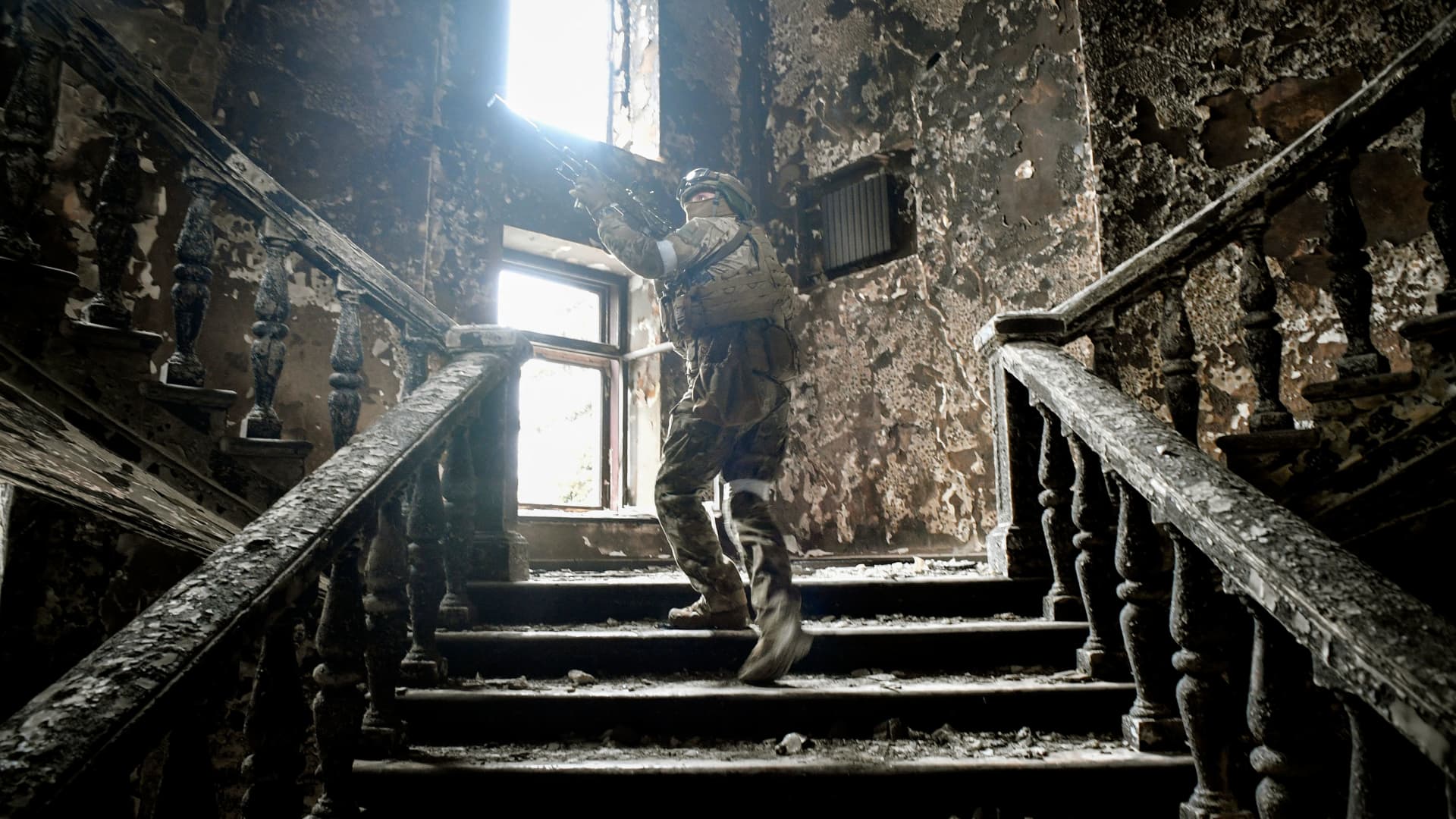 A Russian soldier patrols the Mariupol Drama Theatre, which was hit March 16 by an airstrike, on April 12, 2022 in Mariupol. Editor's note: This picture was taken during a trip organized by the Russian military.