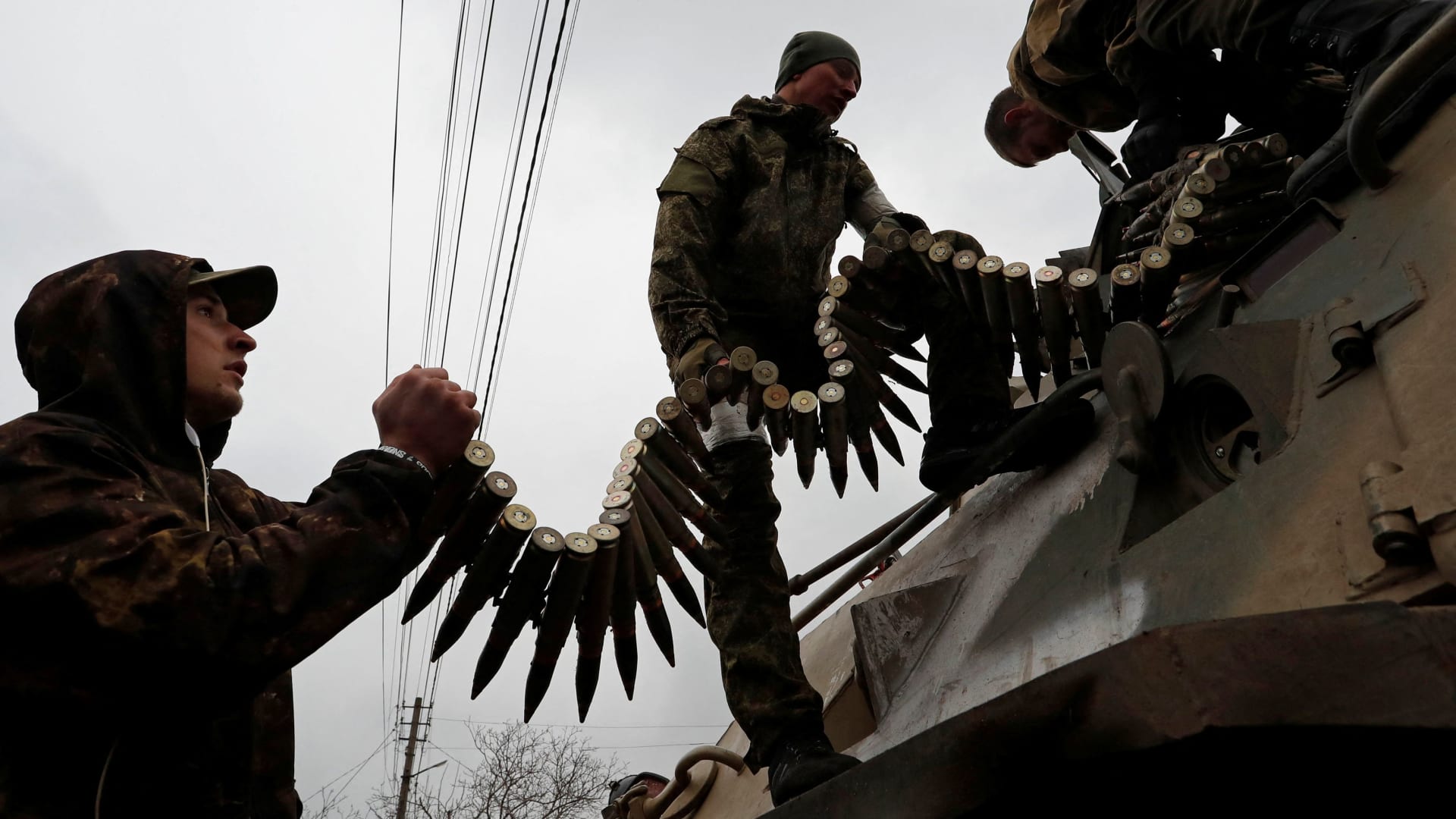 Service members of pro-Russian troops load ammunition into an armoued personnel carrier during fighting in Ukraine-Russia conflict in the southern port city of Mariupol, Ukraine April 12, 2022.