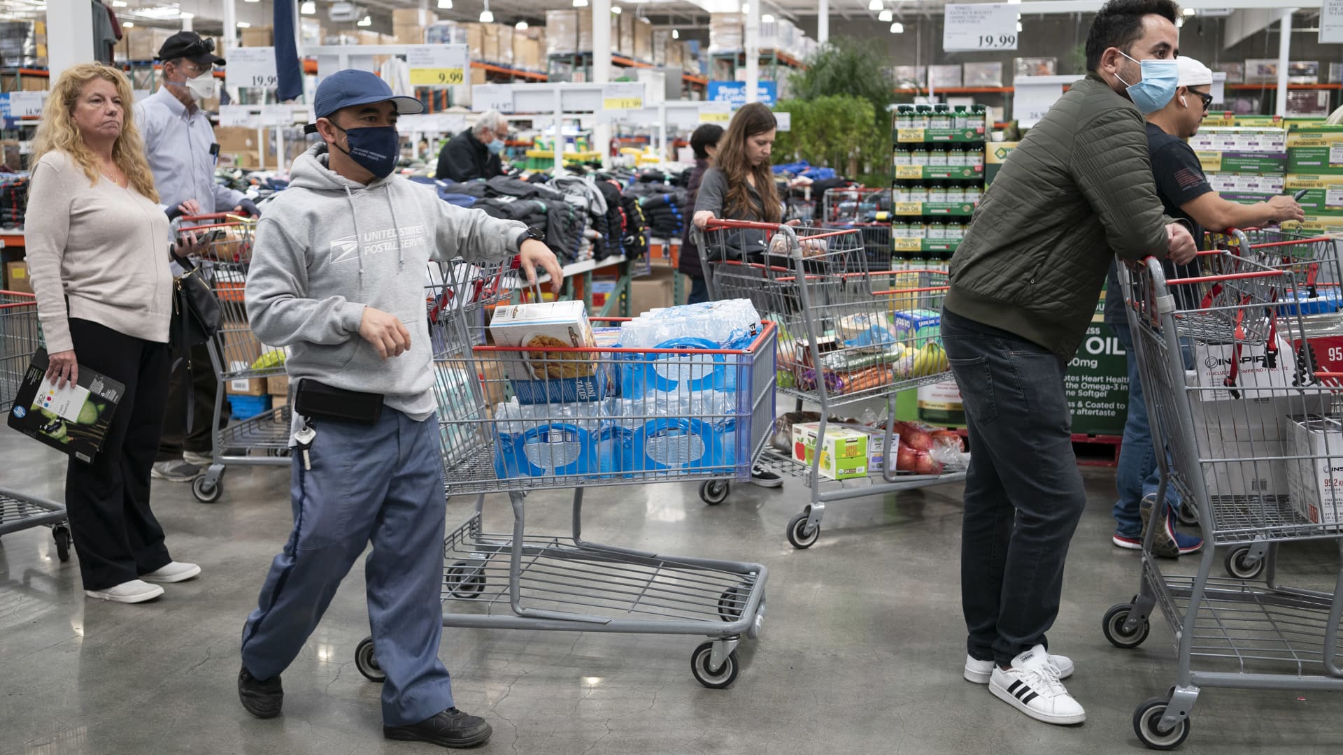 Customers pushing shopping carts shop at a supermarket on April 12, 2022 in San Mateo County, California.