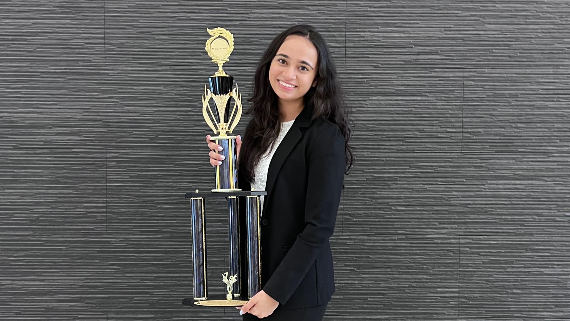 High school senior Sahaar Khoja, pictured after winning a competition for Junior Achievement company, factored in cost when choosing a college to attend in the fall.