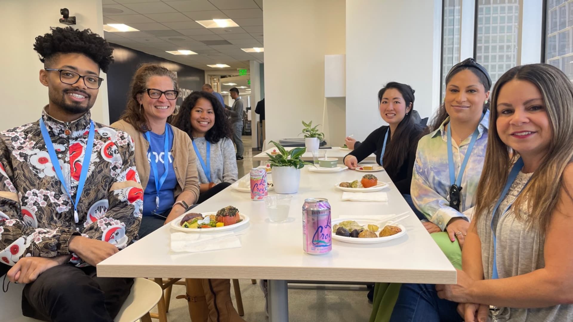 Nicole Perzigian eating lunch with co-workers during their first day back at Zoom's headquarters in San Jose