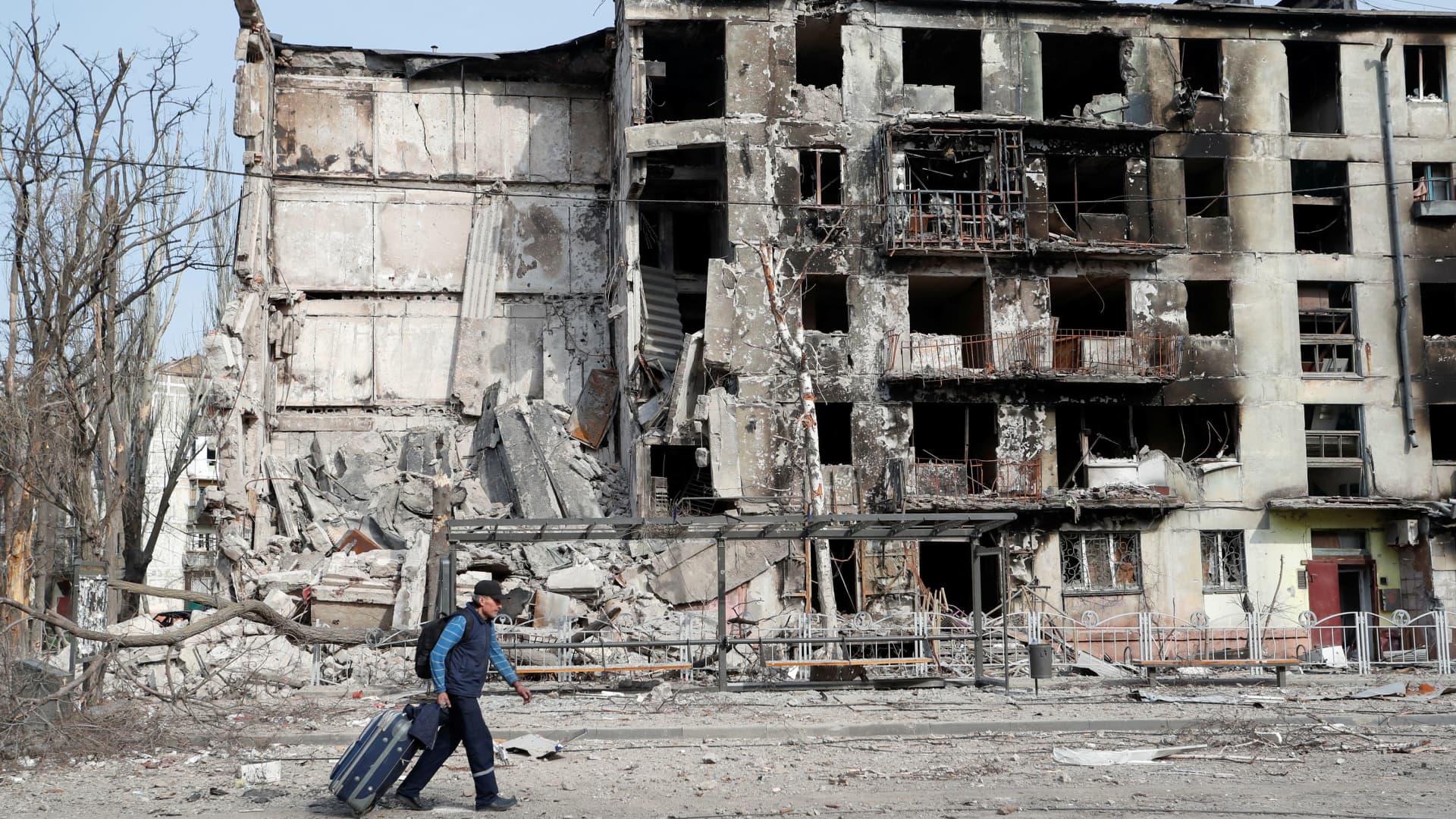 A man walks past a residential building that was destroyed during Ukraine-Russia conflict in the southern port city of Mariupol, Ukraine, on April 17, 2022.