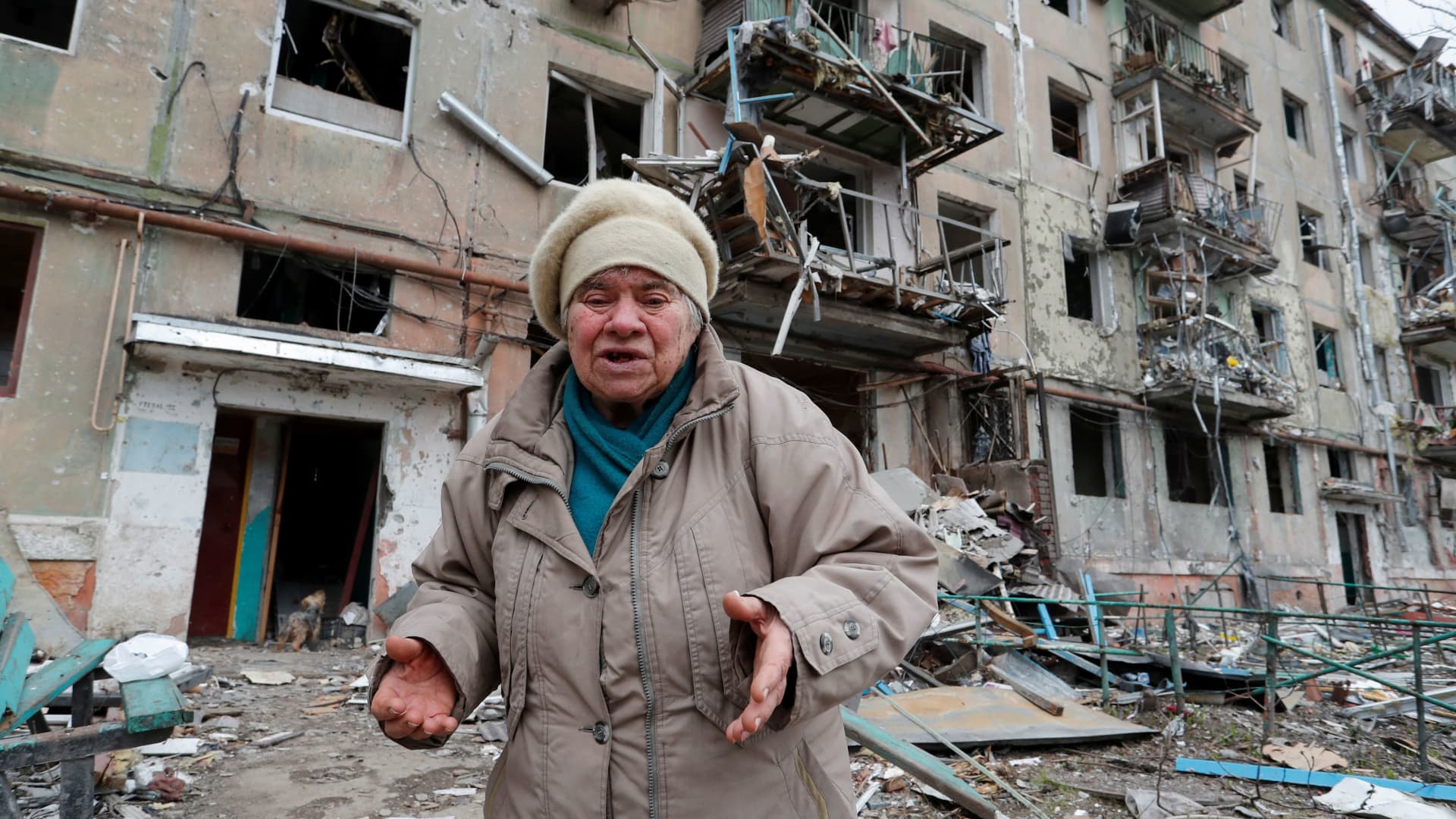A local resident reacts while speaking outside a block of flats heavily damaged during Ukraine-Russia conflict in the southern port city of Mariupol, Ukraine April 18, 2022.