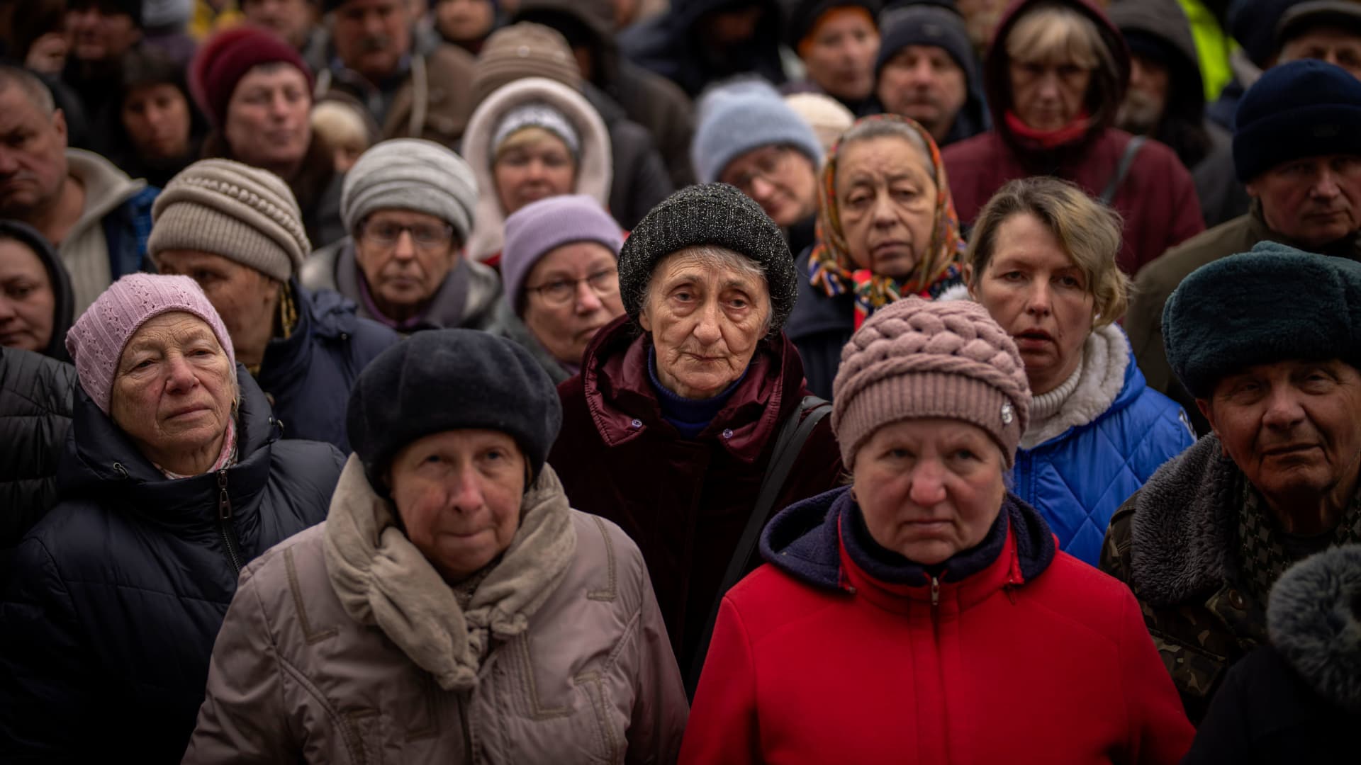 Ukrainians wait for a food distribution organized by the Red Cross in Bucha, on the outskirts of Kyiv, on Monday, April 18, 2022.