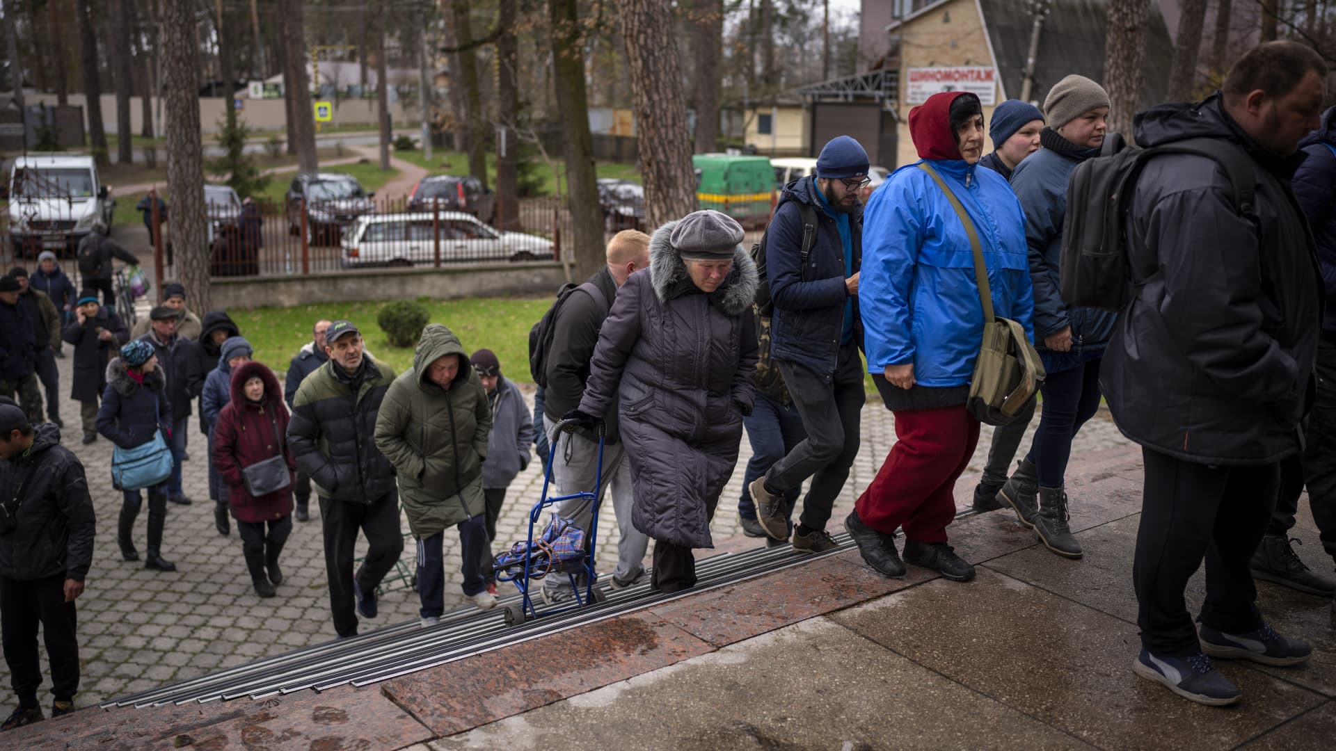 Ukrainians enter a church to receive humanitarian aid donated by European Union in Bucha, on the outskirts of Kyiv, on Tuesday, April 19, 2022.