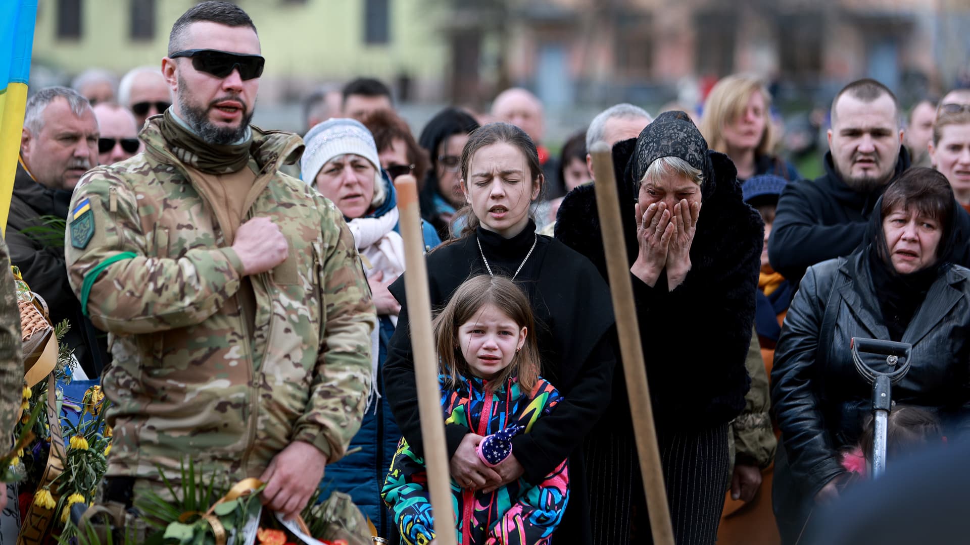On April 17, a mother holds her daughter at the funeral of her husband, a Ukrainian soldier killed in the Donbas area of Ukraine. Moscow is refocusing its attacks on Donbas.