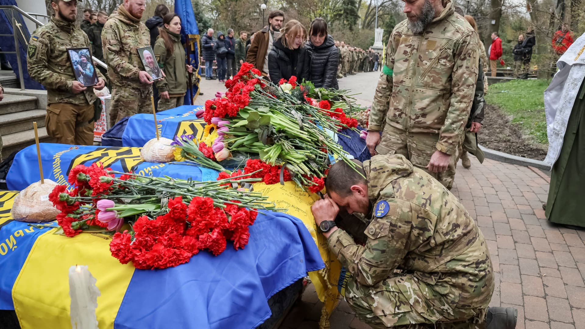 Servicemen of the Ukrainian National Guard attend the funeral of four of their fellow servicemen, who were killed during Russia's invasion of Ukraine, in Kyiv, Ukraine, April 20, 2022.