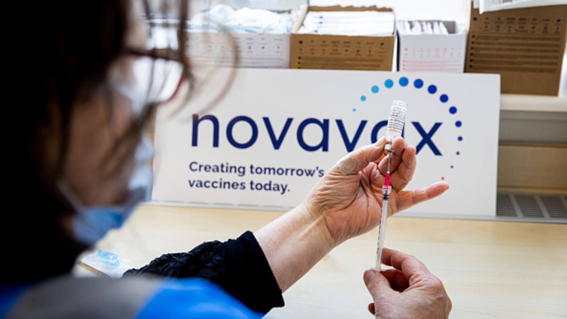 A health worker prepares a dose of the Novavax vaccine as the Dutch Health Service Organization starts with the Novavax vaccination program on March 21, 2022 in The Hague, Netherlands.