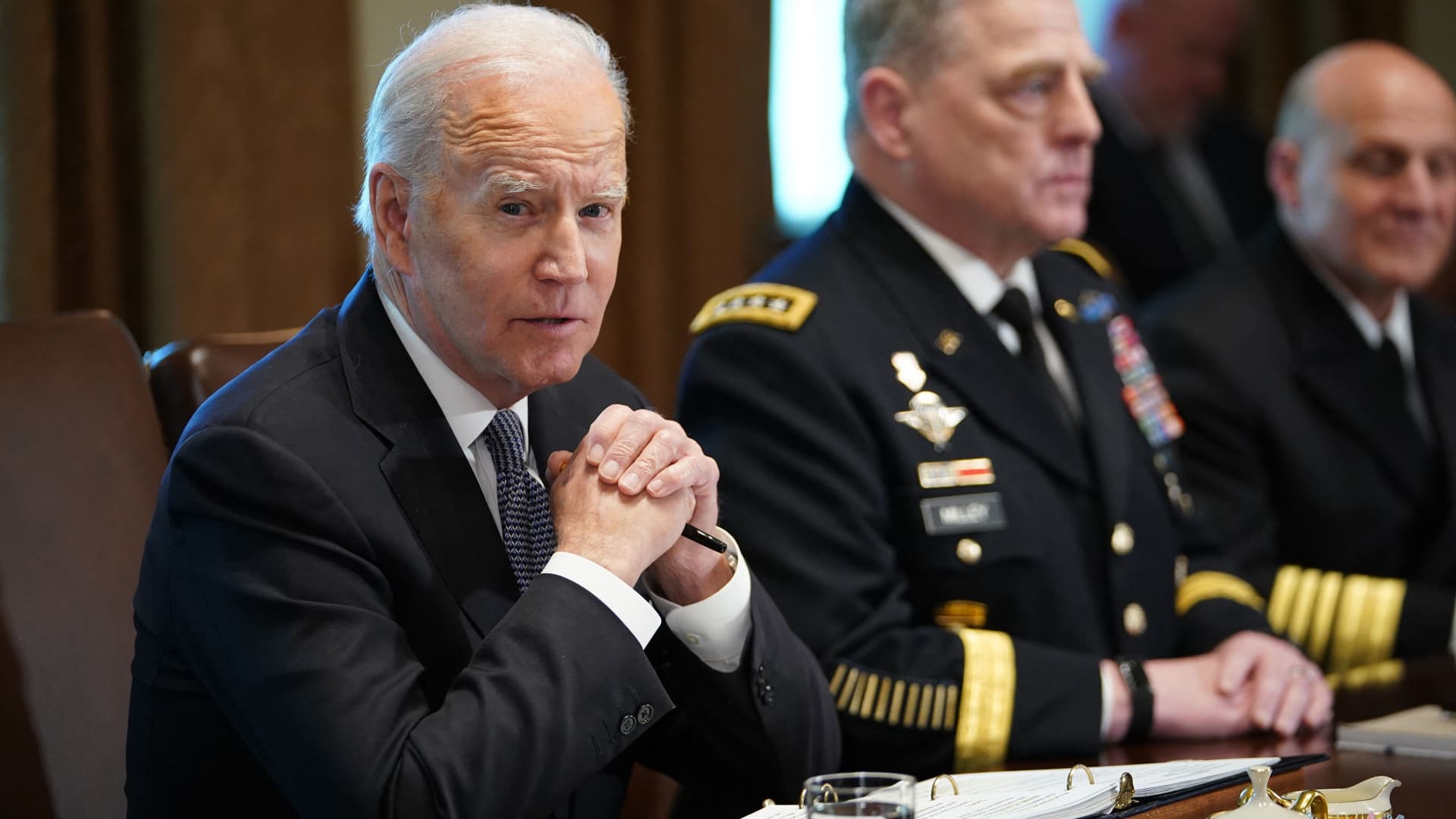 US President Joe Biden (L) meets with Defense Secretary Lloyd Austin, Deputy Defense Secretary Kathleen Hicks, Chairman of the Joint Chiefs of Staff General Mark Milley, the Joint Chiefs of Staff and Combatant Commanders in the Cabinet Room of the White House in Washington, DC on April 20, 2022.