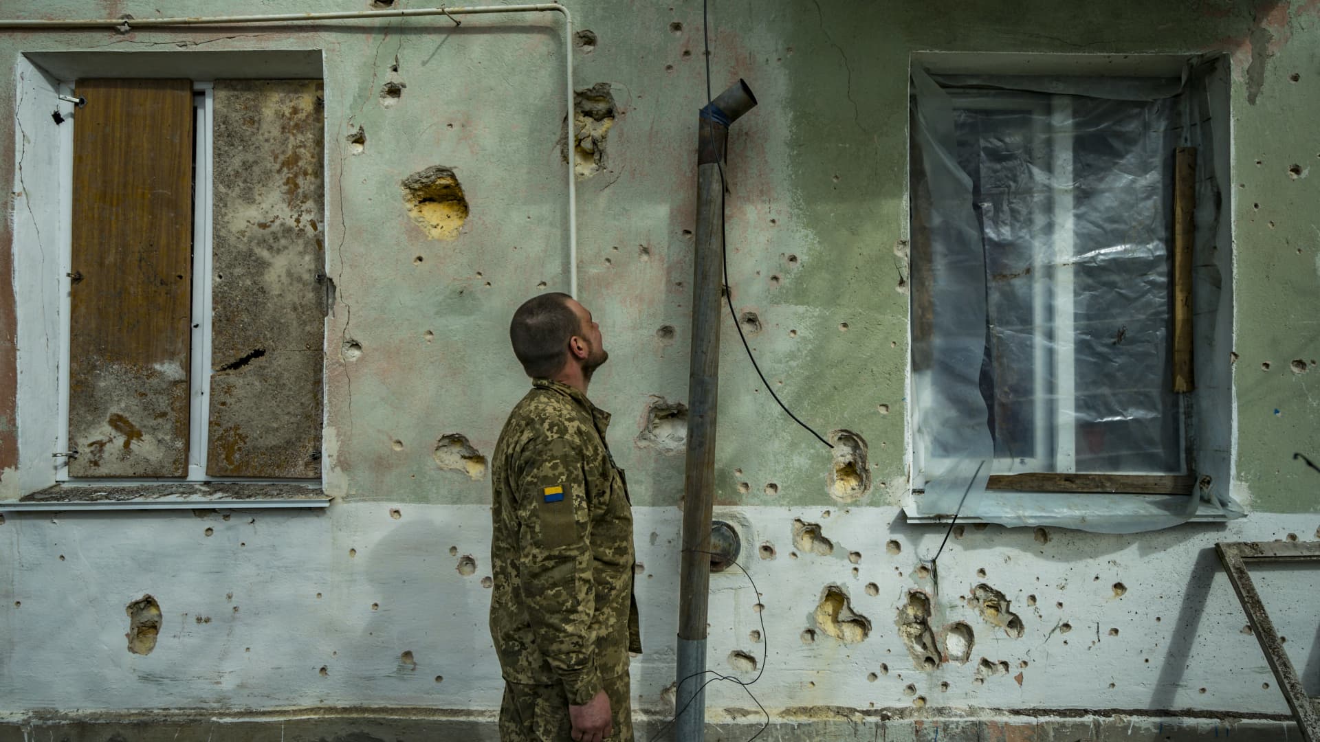 Ukrainian soldier checks the destruction of the shrapnel in a wall of a village near the frontline of Mykolaiv after a Russian shelling. A plan developed by a team of Ukrainian and international experts to strengthen sanctions against Russia has been published, Ukrainian President Volodymyr Zelenskyy said in his nightly video address on Wednesday.