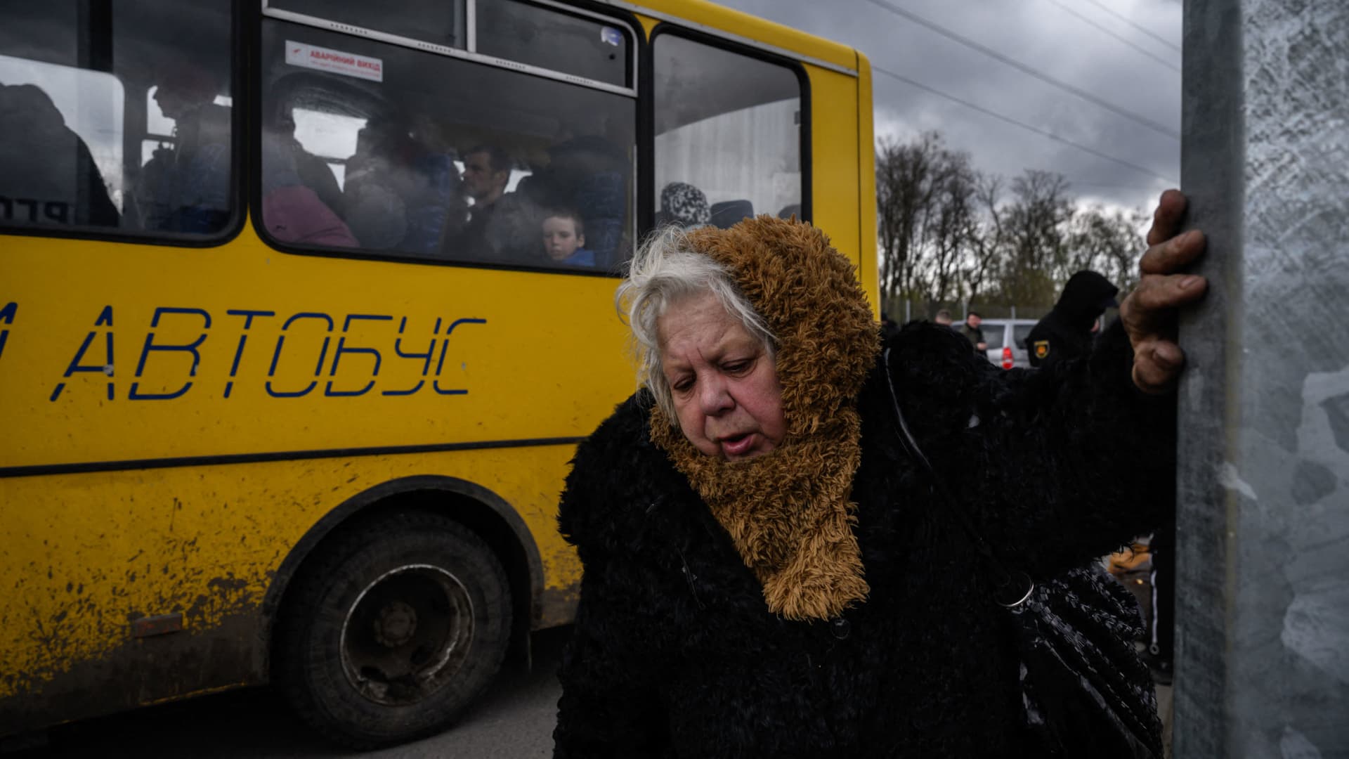 People fleeing fighting in the southern city of Mariupol meet with relatives and friends as they arrive in a small convoy after the opening of a humanitarian corridor, at a registration center for internally displaced people in Zaporizhzhia on April 21, 2022.