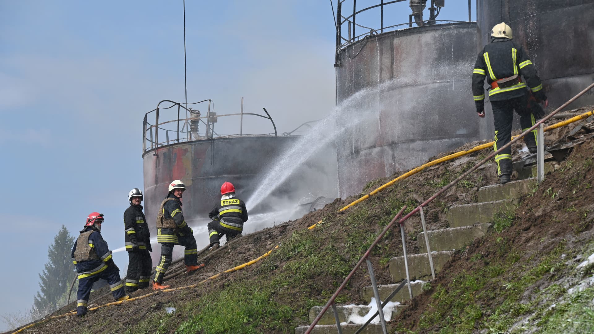 Firefighters are at work to put out a fire at an oil depot near Chuguiv, Kharkiv region, following Russian missiles strikes on April 22, 2022, amid Russian invasion of Ukraine.