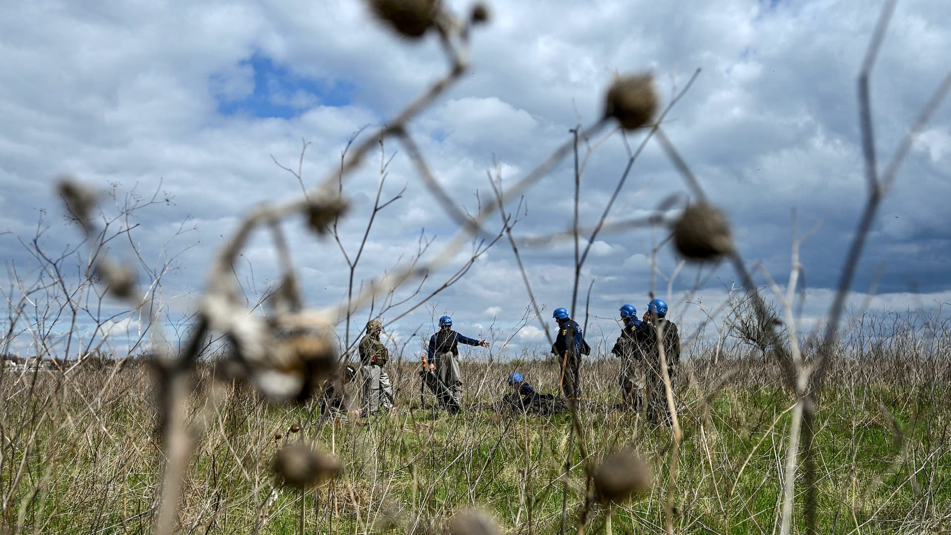 Experts of a State Emergency Service bomb squad work to dispose of the dangerous remains of an Uragan rocket on the pasture, Hryhorivka, Zaporizhzhia Region, southeastern Ukraine. Ukraine has accused Russia of plans to conscript Ukrainian civilian in the occupied region of Zaporizhzhia, a move the UK defense ministry says is a violation of Article 51 of the Fourth Geneva Convention.