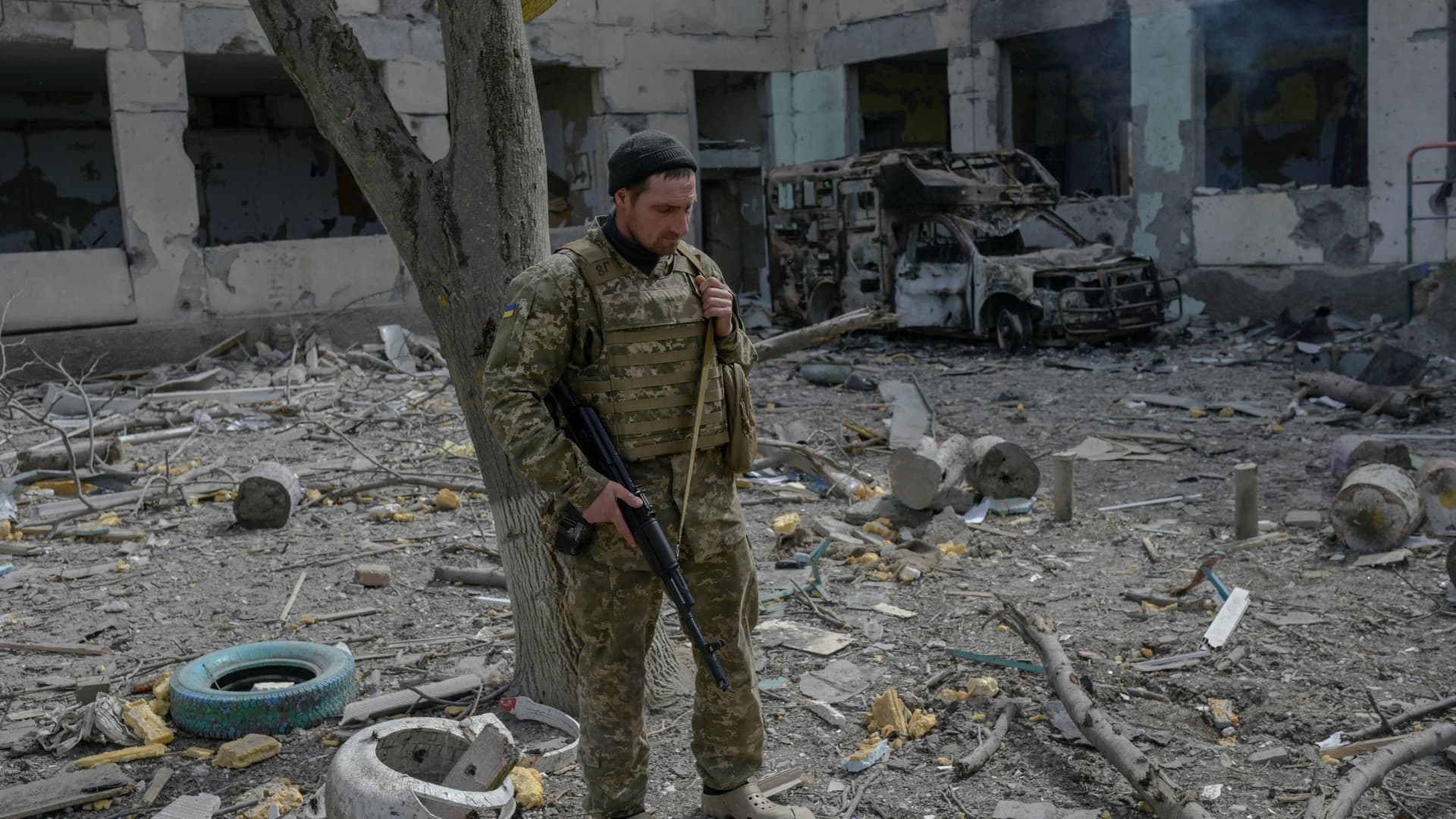 A Ukrainian soldier stands outside a school hit by Russian rockets in southern Ukraine village 220401. Russia is planning a staged referendum in Kherson, Ukraine, to justify its occupation, the British defense ministry said in an intelligence update.