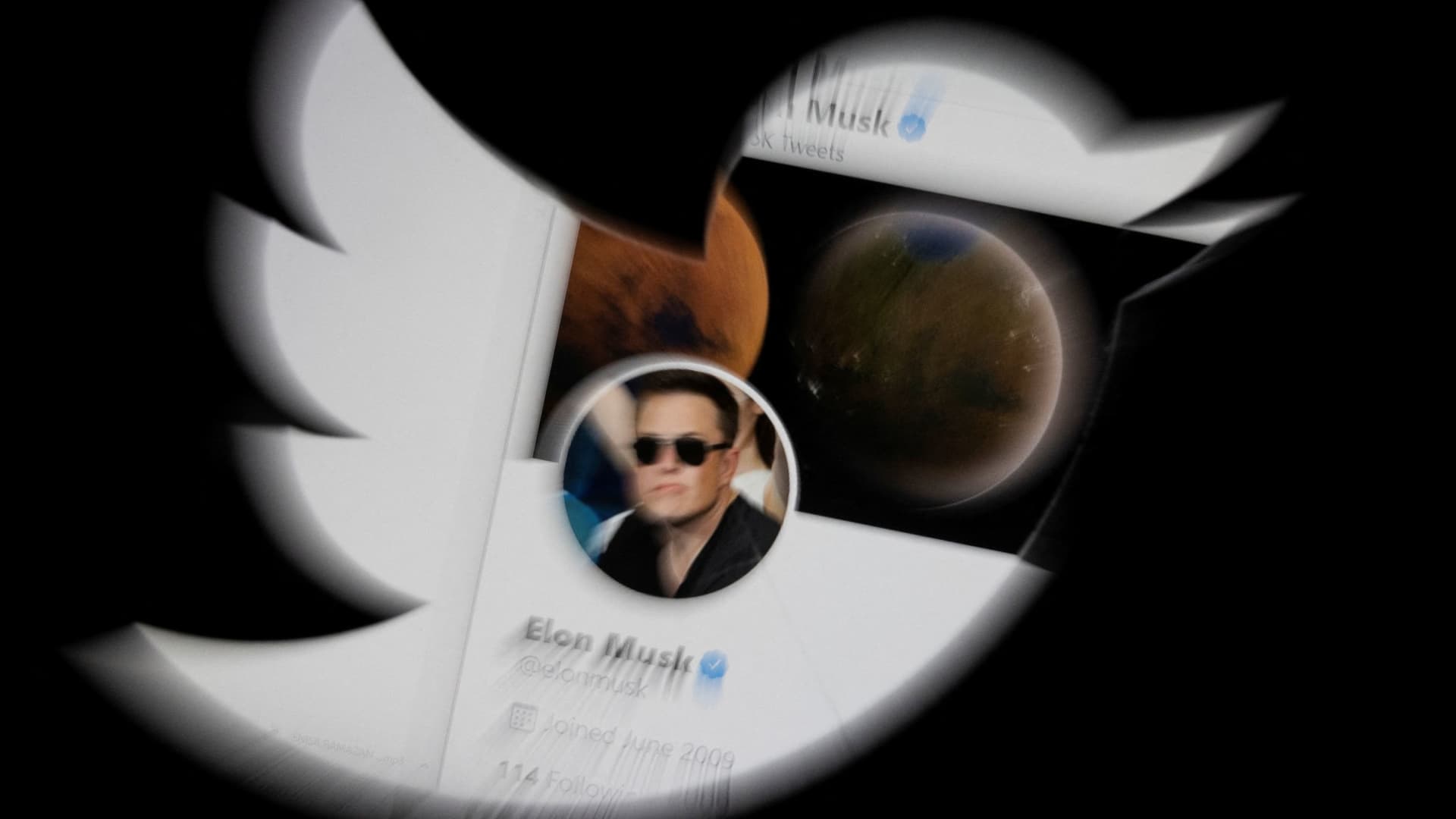 Elon Musk twitter account is seen through Twitter logo in this illustration taken, April 25, 2022. 