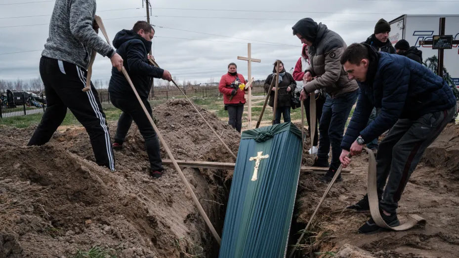 Relatives of Mykhailo Romaniuk, 58, who was shot dead on his bicycle on March 6, help to bury his coffin at a cemetery in Bucha, on April 19, 2022, during the Russian invasion of Ukraine.