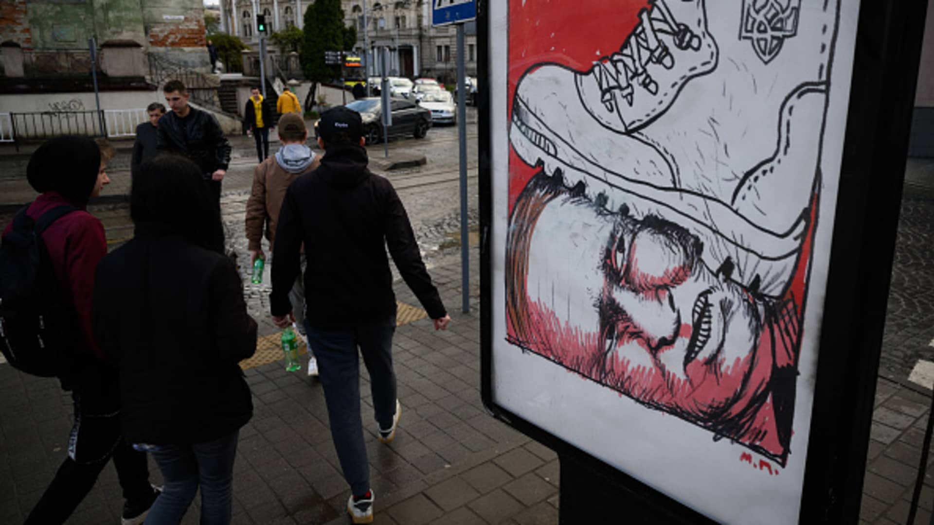 A satirical poster featuring the boot of the Ukrainian army pressing on the head of Russian President Vladimir Putin is seen on April 25, 2022 in Lviv, Ukraine.