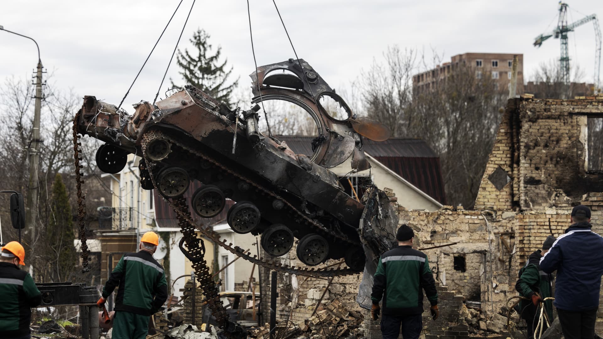 A destroyed Russian tanks is removed on April 5, 2022 in Bucha, Ukraine.
