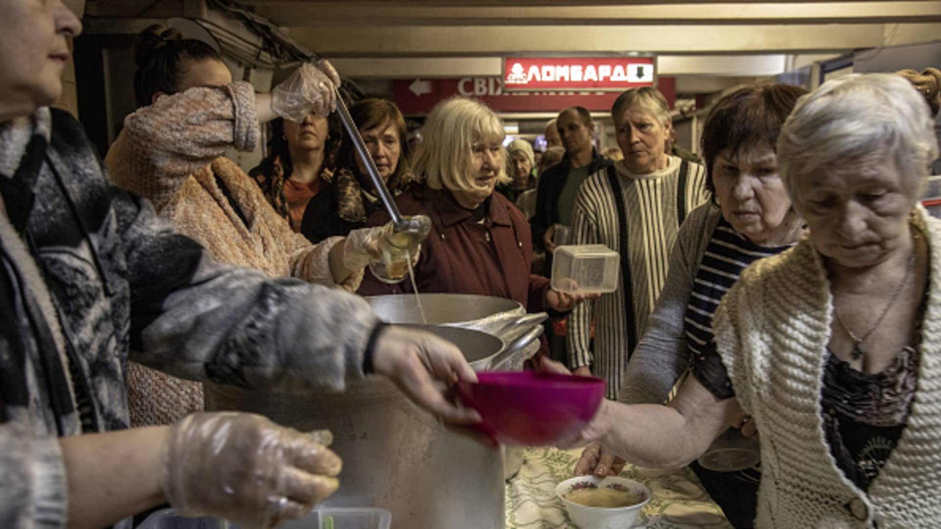 Elderly queue for food distribution in a metro station used as bomb shelter in the Saltivka neighborhood of Kharkiv City, Ukraine, on April 25, 2022.