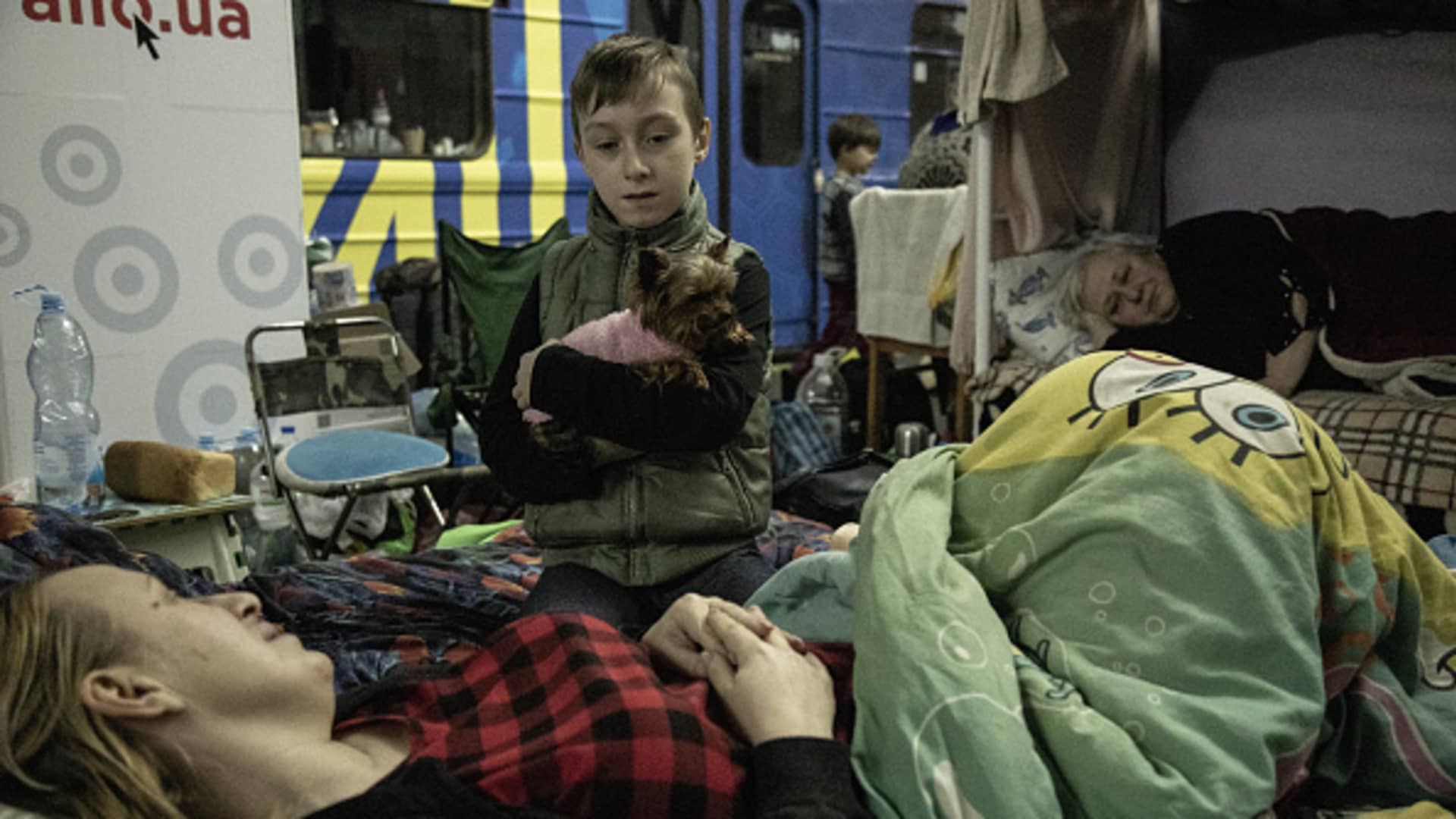 Pasha, holds a dog on his arms, in a metro station used as bomb shelter in the Saltivka neighborhood of Kharkiv City, Ukraine, on April 25, 2022. 