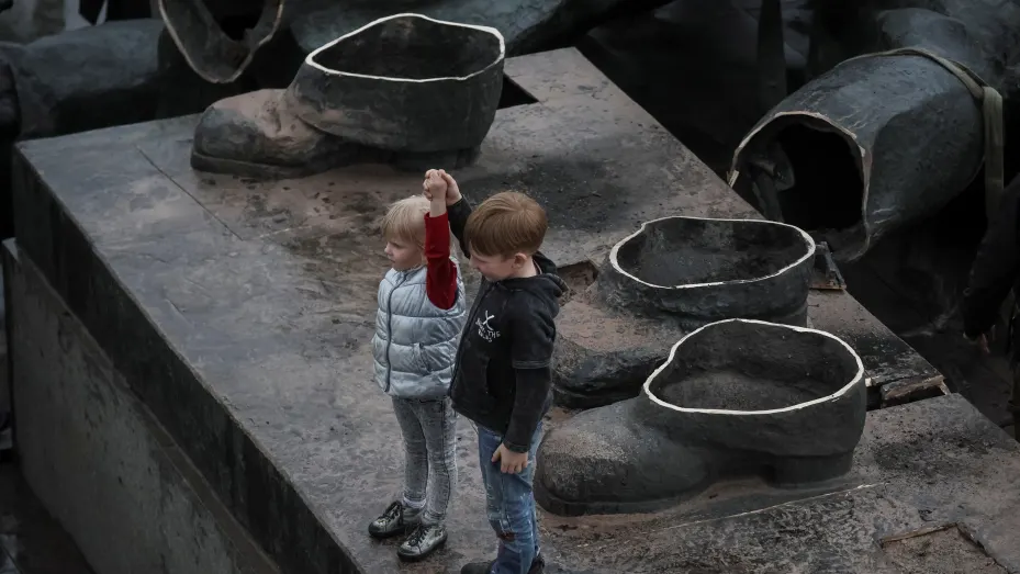 Children depict a Soviet monument to a friendship between Ukrainian and Russian nations after its demolition, amid Russia's invasion of Ukraine, in central Kyiv, Ukraine April 26, 2022.