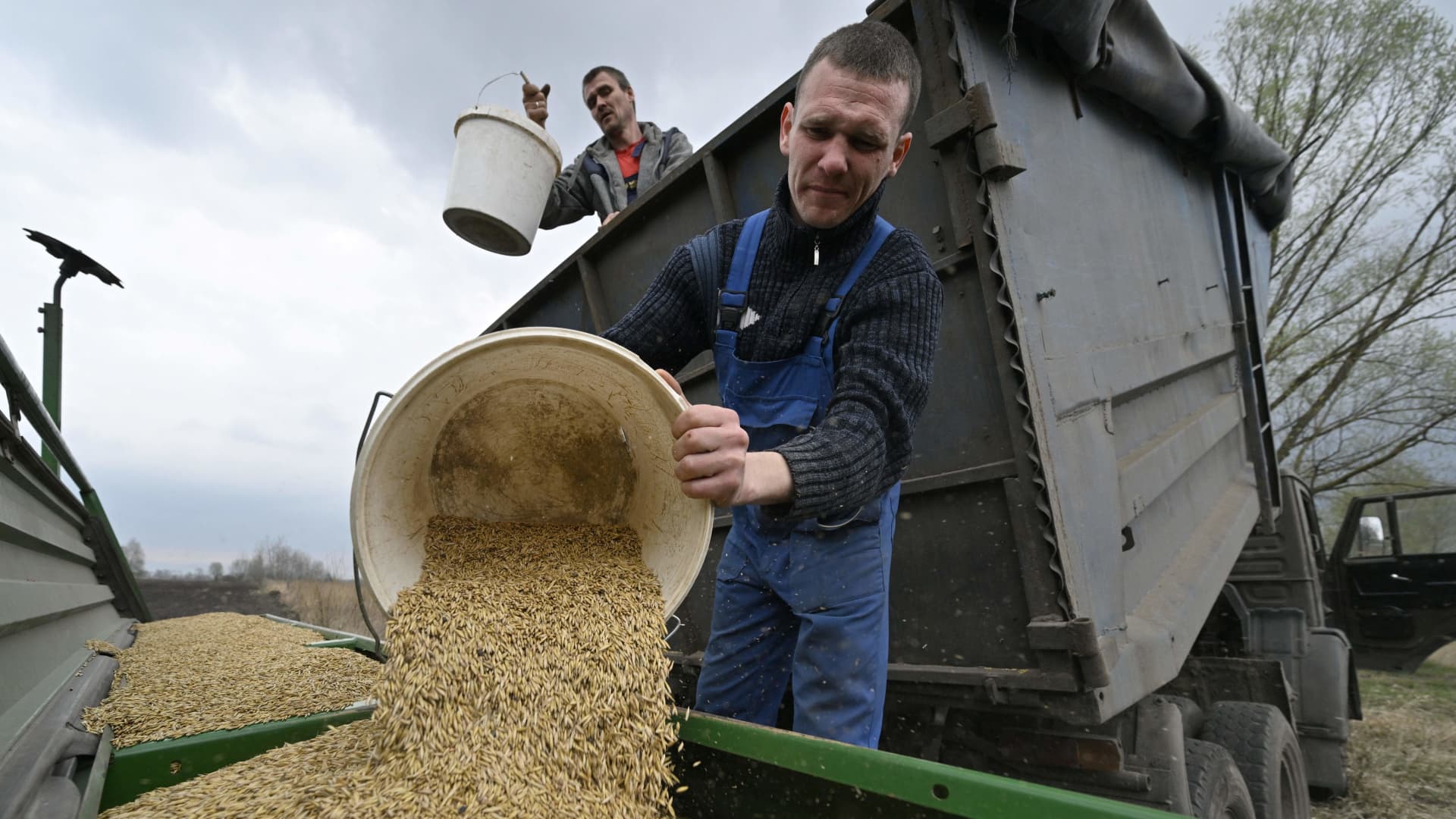 Farmers load oat in the seeding-machine to sow in a field east of Kyiv on April 16, 2022. The U.K. announced on Monday all tariffs and quotas on goods from Ukraine will be removed under the free trade agreement.