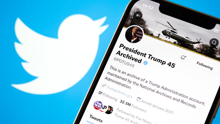 In this photo illustration, former U.S. President Donald Trump's archived Twitter account is shown on a phone screen with the Twitter logo in the background.